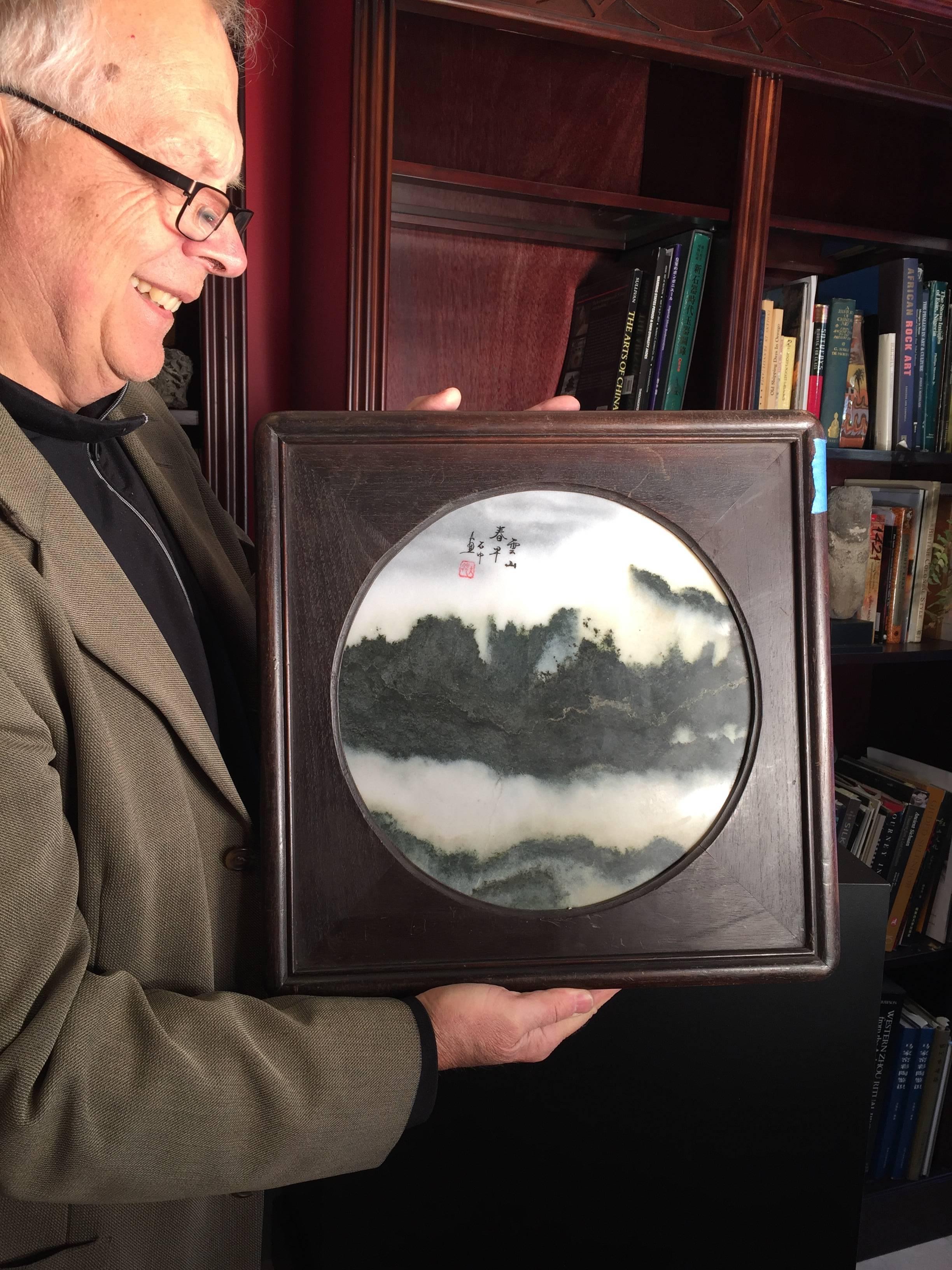 This Chinese extraordinary round natural stone painting of a mountain range in clouds is called a dream stone, Shih-hua;. They are cut from historic Dali marble found in the Cangshan mountains of western China. These mysterious mountains, unique in
