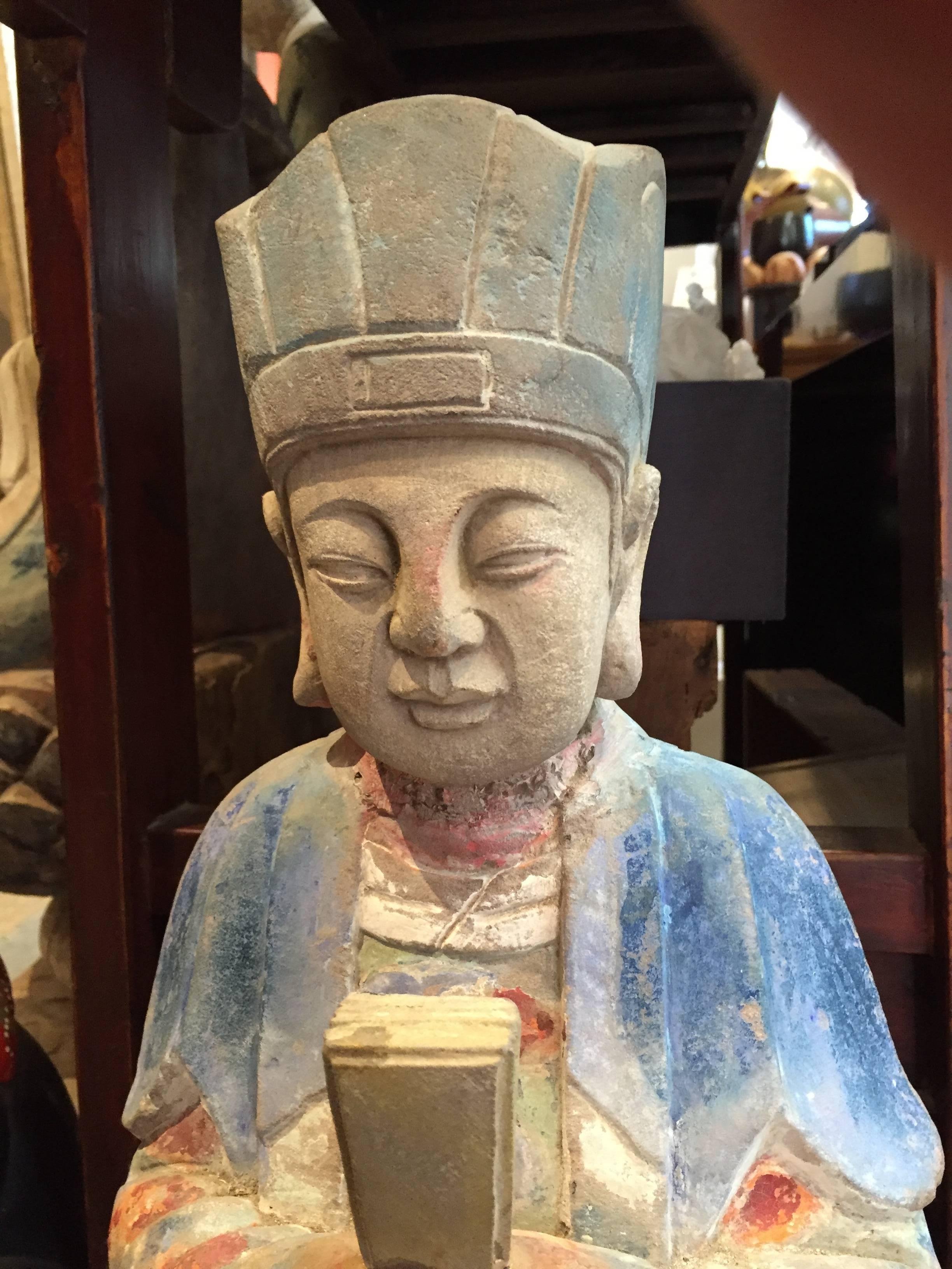 A good opportunity to acquire a tall and handsome effigy of a Chinese scholar clutching a book of knowledge with its original Cheng-du origins temple hand painted surface and hand carved in sand stone.

Coming from our private collection, this