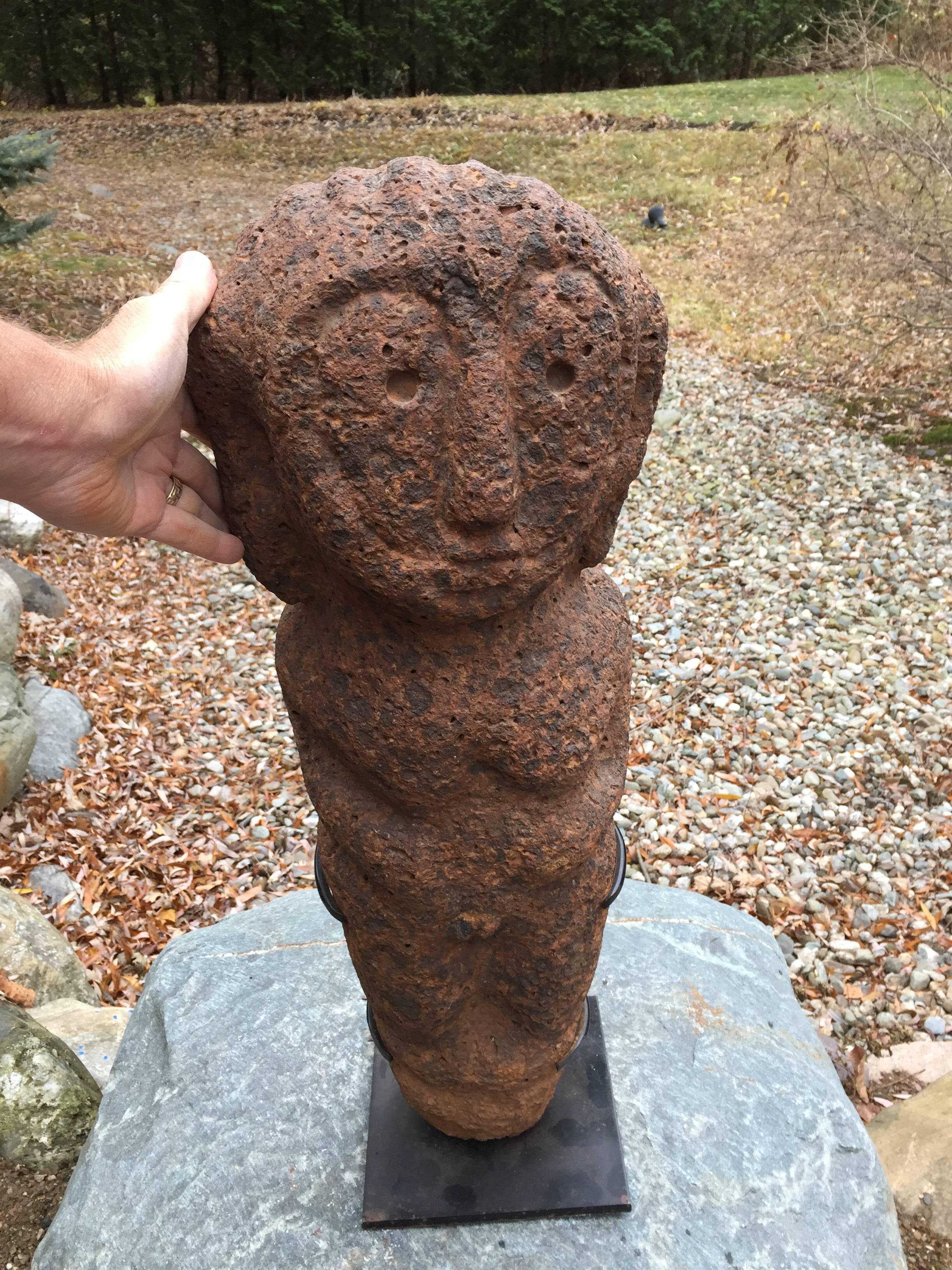 Africa, Bongo Peoples, stone female commemorative figure from Southern Sudan. A fine specimen in naturally weathered condition; hand carved from a porous orange-black stone, 20th century. Similar funerary stone sculptures in various sizes were