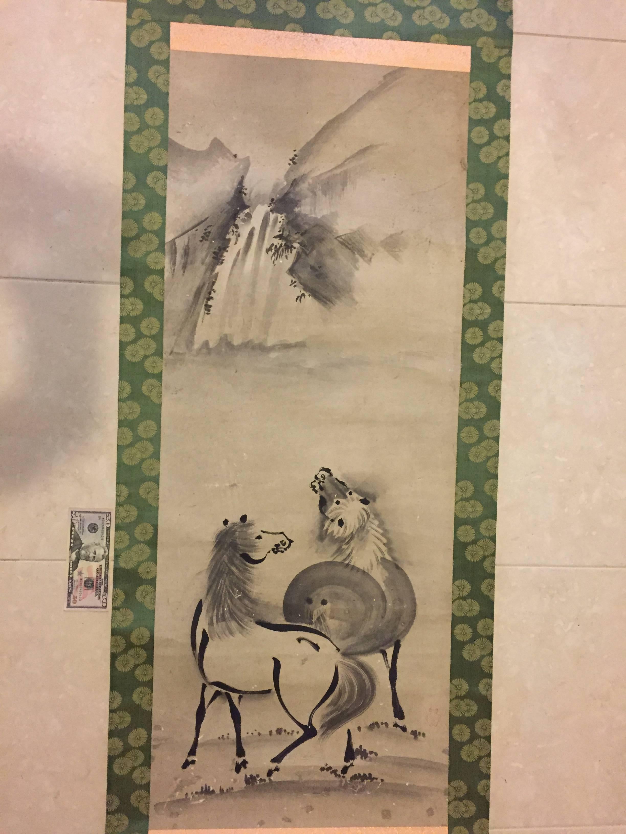 Japan, a hand painting on paper scroll of a waterfall with two horses; Kano style, signed on lower left.

Period:  Late Taisho to early Showa period, (1920-1930).

Dimensions: 25.5 inches wide and 78 inches length.

Enticing subject matter, this