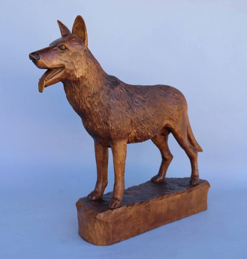 Designer's source.

Germany hand-carved wooden German Shepherd dog finely carved, circa 1900.
 
Designer/Maker: From Germany or Austria, 1900. 

Additional comments: Finely carved with very nice dark orange patina signifying good