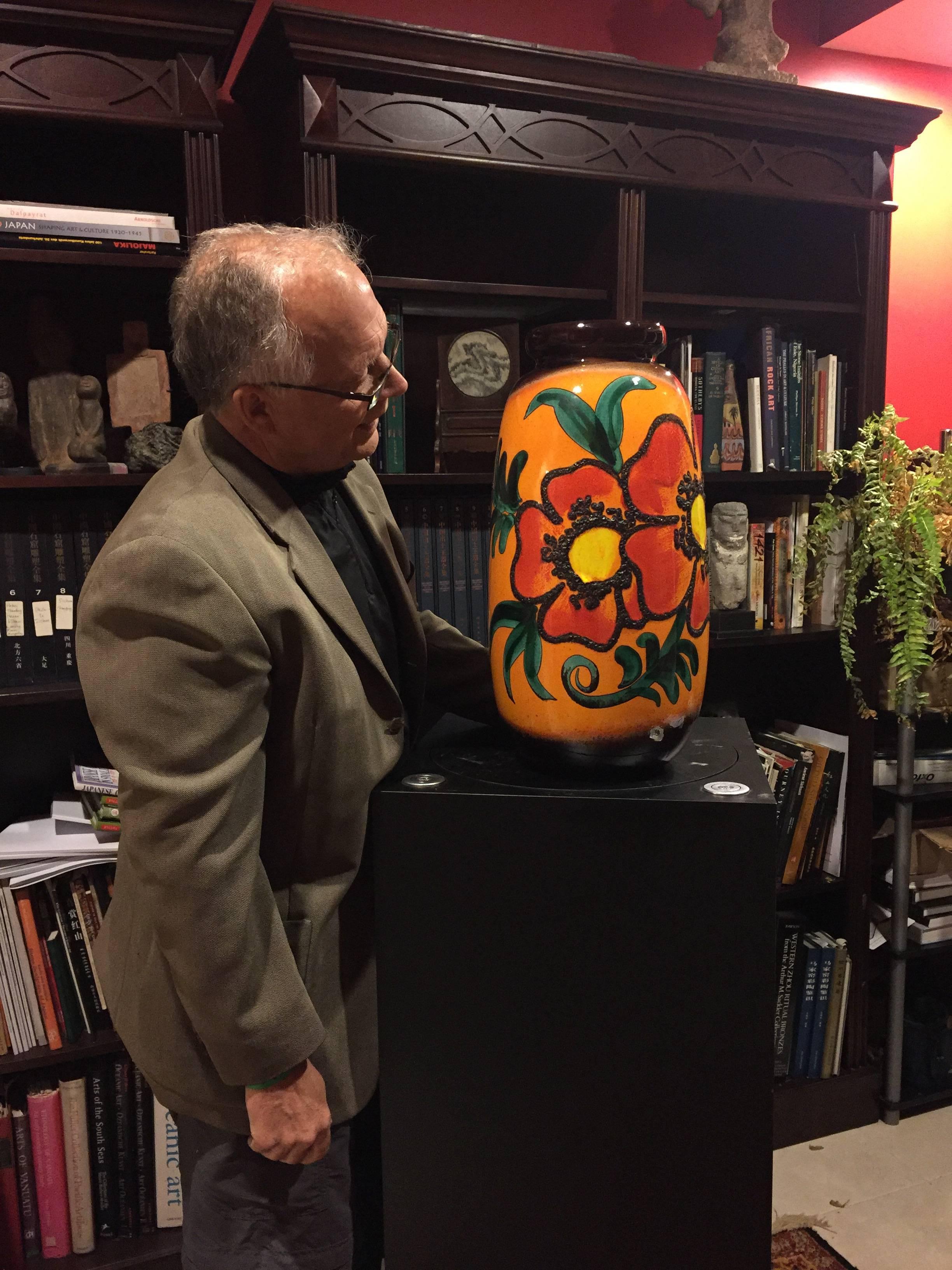 Designers Source

An early contemporary hand made and hand glazed so called Fat Lava classic flower vase with brilliant colors,  about 1960  

Designer/Maker: probably Scheurich, about 1960

Glaze: The orange, green, red, and black colors showcase