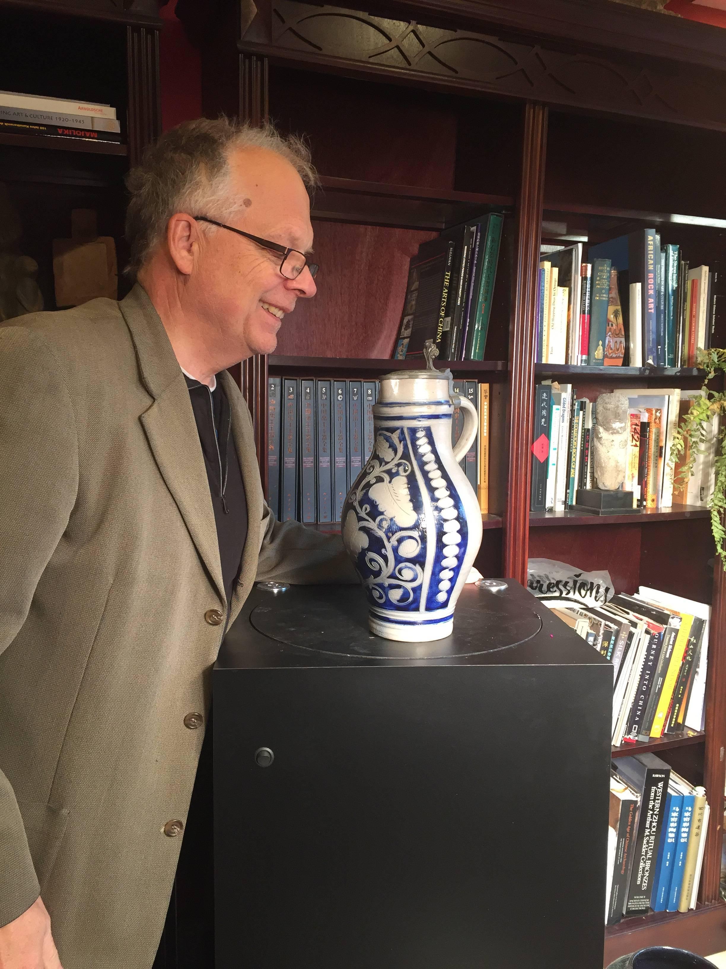 Here's a tall and fine arts and crafts antique blue salt glazed beer mug or pitcher dated 1882. Original pewter lid with engraved date. Finely carved cobalt blue floral ornamental decor with the number three hand-painted and glazed near handle