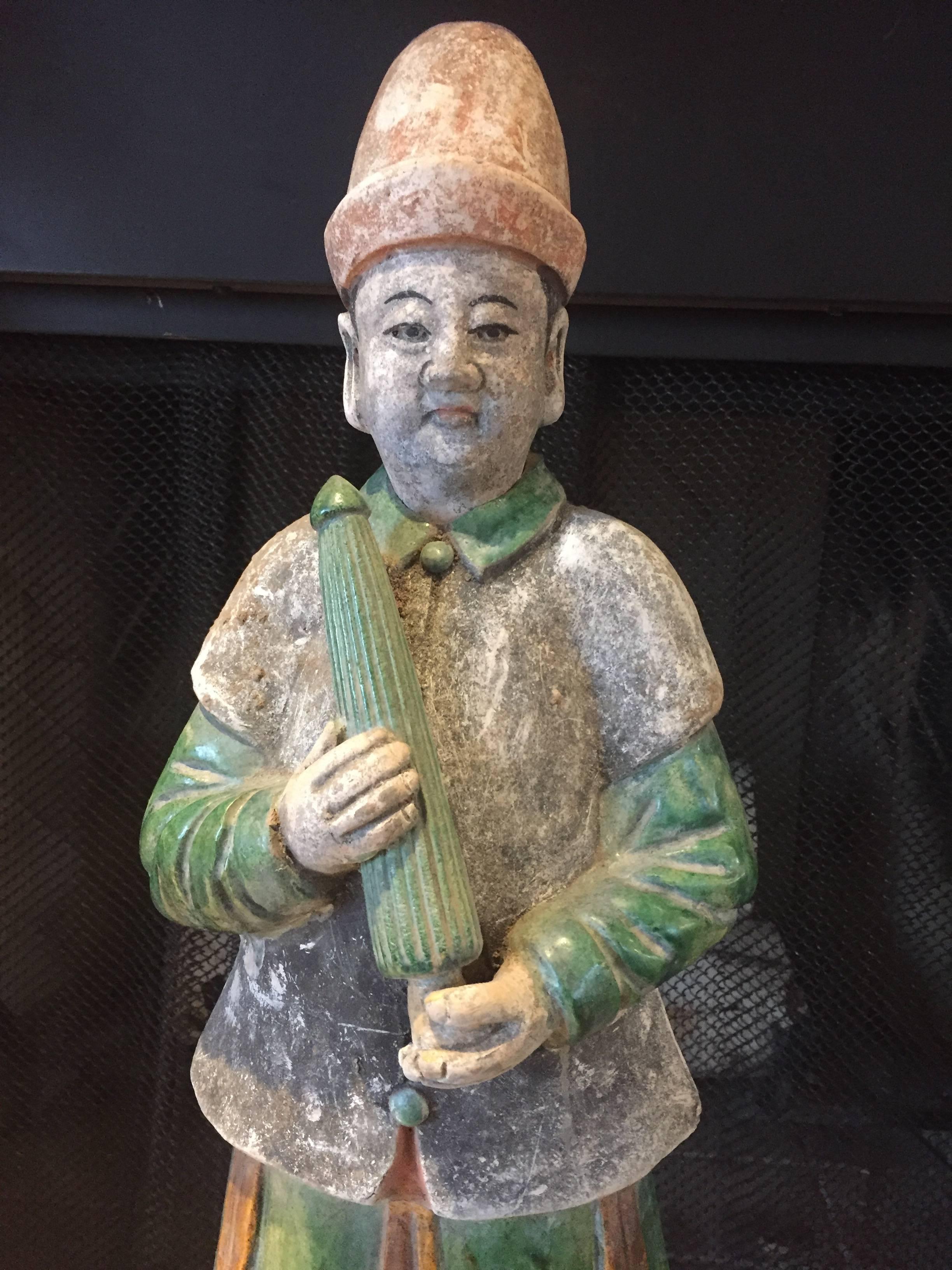 Important ancient Imperial China Ming tomb treasure attendant, 1368-1644, 26 inches in height. This large attendant brandishing an umbrella is one of a small group of monumental attendants recently available from an old European collection and