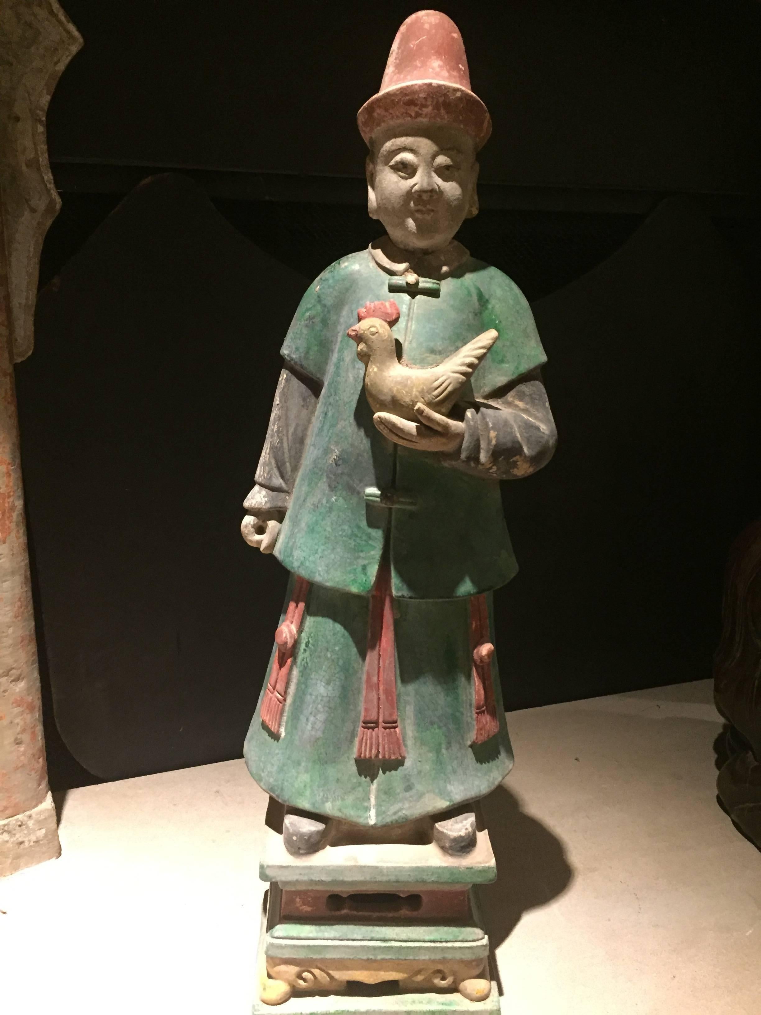 Important ancient Imperial China Ming tomb treasure attendant, 1368-1644, 26 inches in height. 

This large attendant caressing  a rooster is one of a small group of monumental attendants recently available from an old European collection and