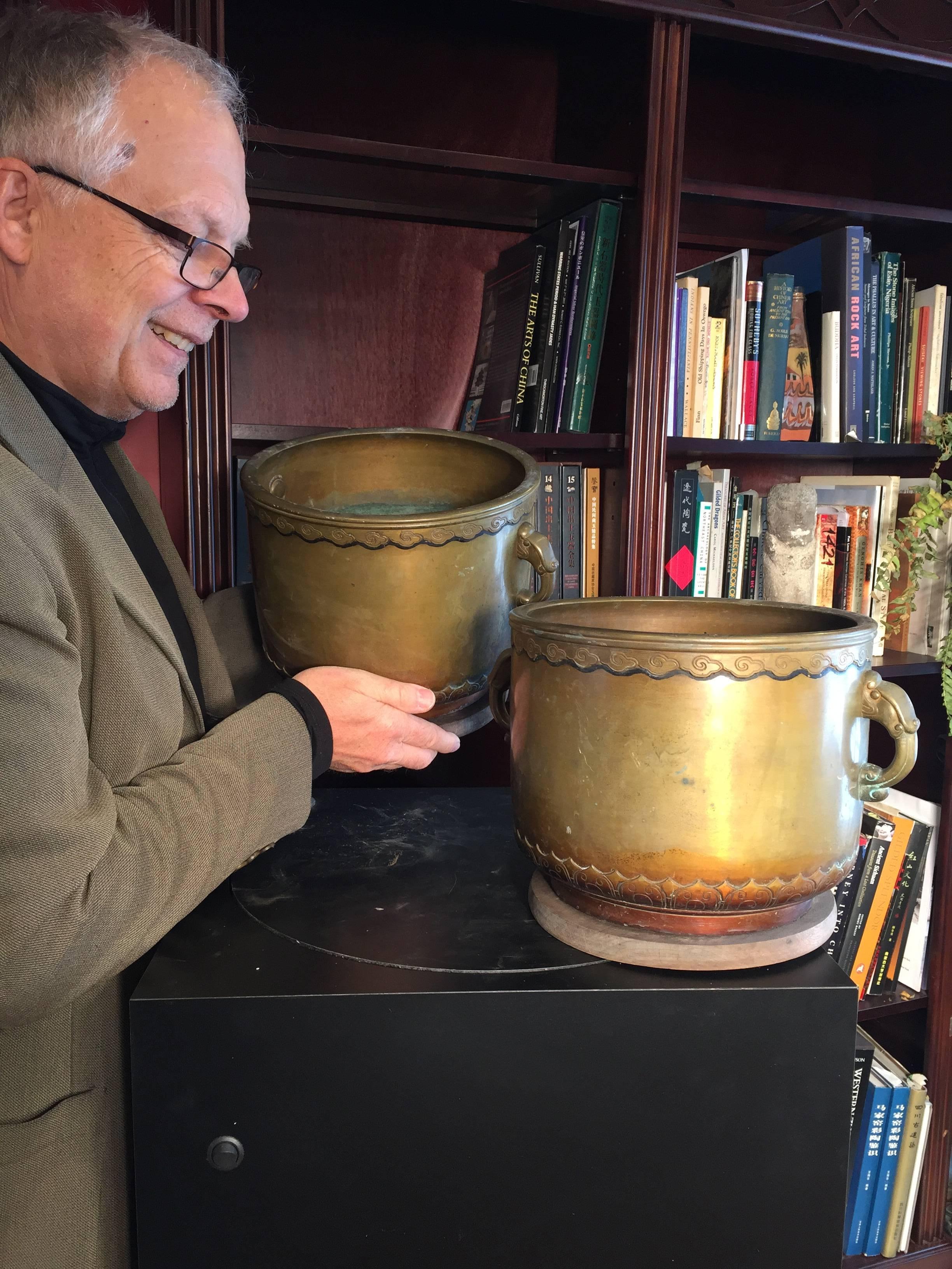 Japan, a lovely late Meiji heavy hand caste bronze pair planters now used as superb planters and decorative accents. Solid bronze, with wonderful elephant form handles and simple caste bodies with an inlaid and engraved ripple cloud pattern along