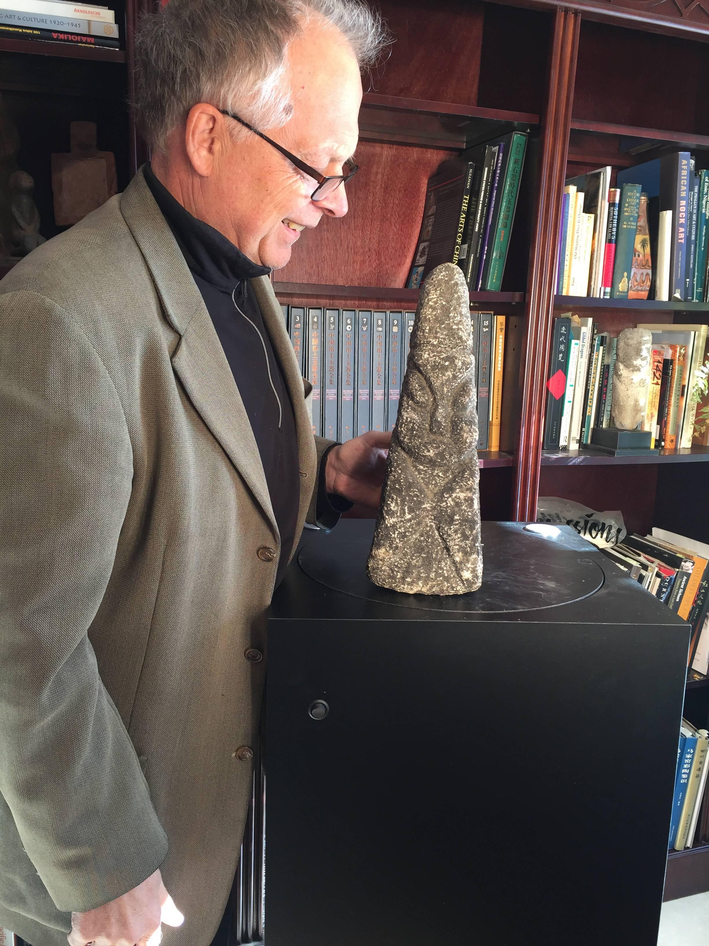 A good opportunity to acquire a very old and unusual hand-carved stone marker in the form of a stylized human. This tall handsome tapered Minimalist sculpture was originally acquired along with several others during one of our many field collecting