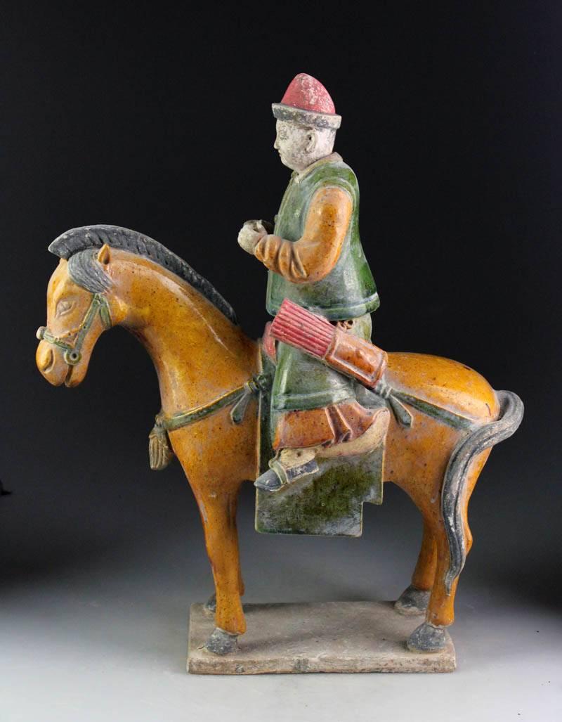 Important ancient Imperial China Ming tomb horse and rider, 1368-1644, 15 inches in height. Crafted in a stunning amber and green color glaze. 

This horseman and his steed is one of a small group of fine quality glazed figurines recently