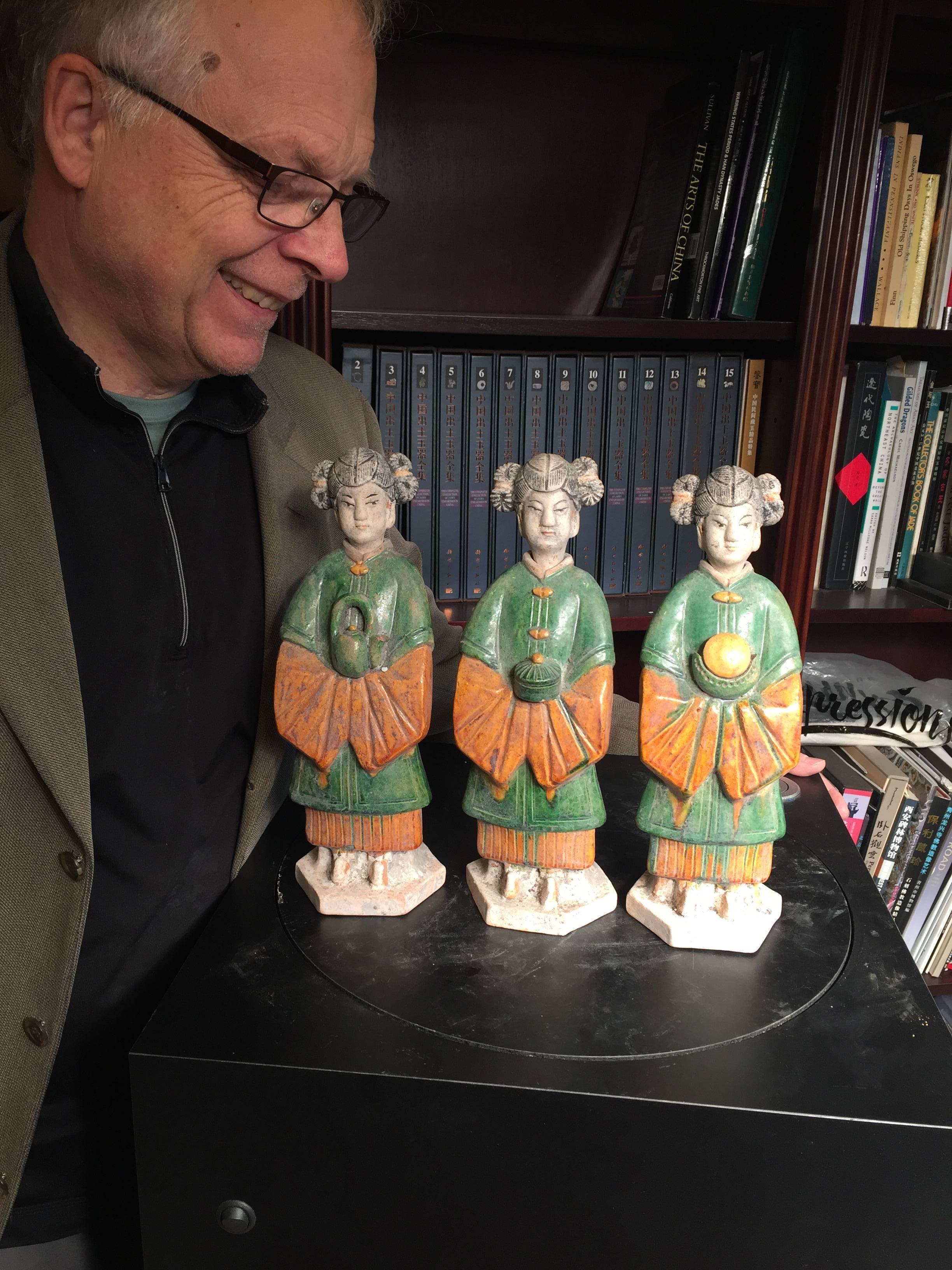 Important Ancient Chinese Trio of three women attendants handmade and hand glazed in green and amber colors - a collection three (3) figures, Ming Dynasty 1368-1644. Superb quality.

The statues each are dressed in long gowns with long sleeves,