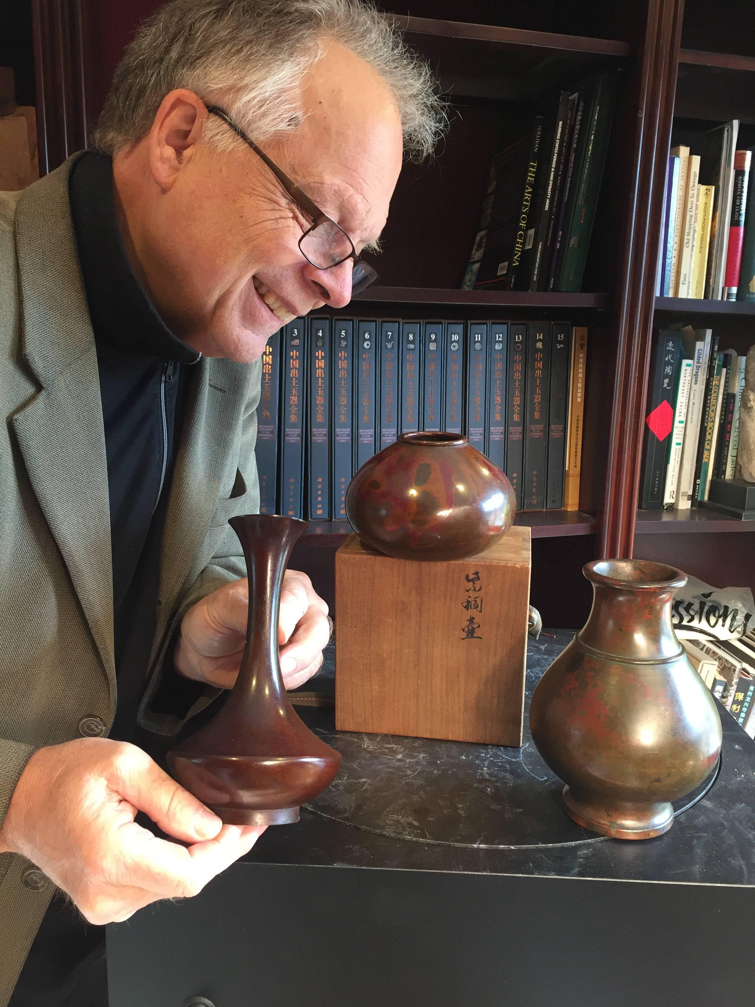 Japan, a one of a kind collection of three hand cast bronze vases masterfully hand finished in a sumptuous murashido red oil spot patina red with green and dark brown highlights. Murashido is a dipping technique where the hot bronze is covered in