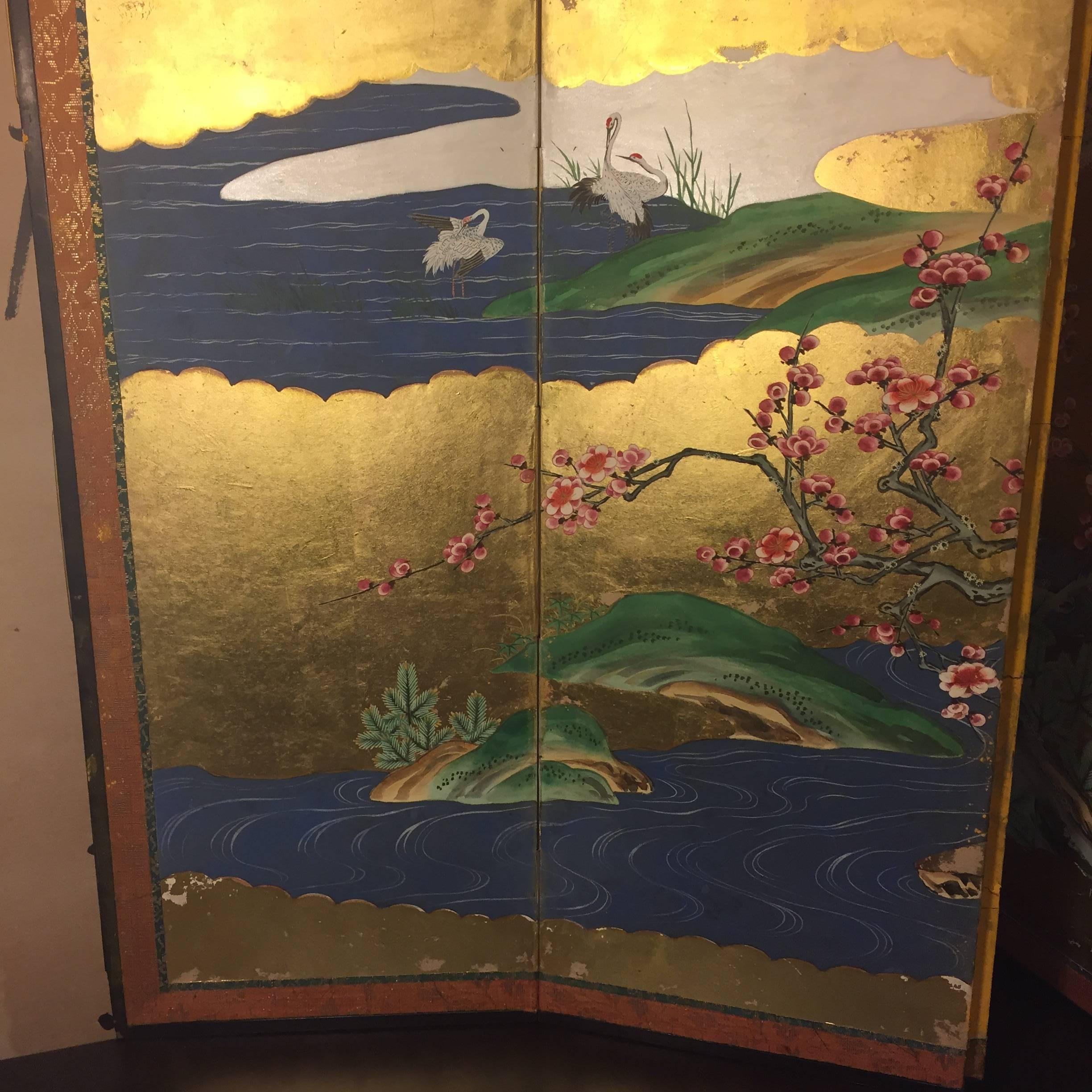 A fine small-scale Japanese antique hand-painted six panel folding screen byobu conceived in a convenient size 13.5 inches high and 36 inches long. Lovely vivid colors featuring Classic colorful spring and summer subject matter: cranes, cherry