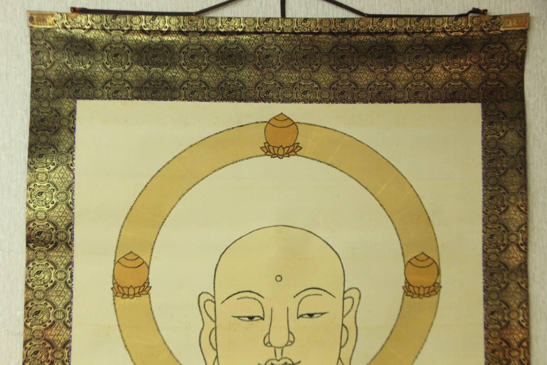 Japan, an important large Temple silk scroll painting of a bodhisattva Arhat holy man practicing the “Soham” meditation mudra right and clasping the hoju wish granting jewel in his left hand standing atop a lotus base. This beautiful and sensitive