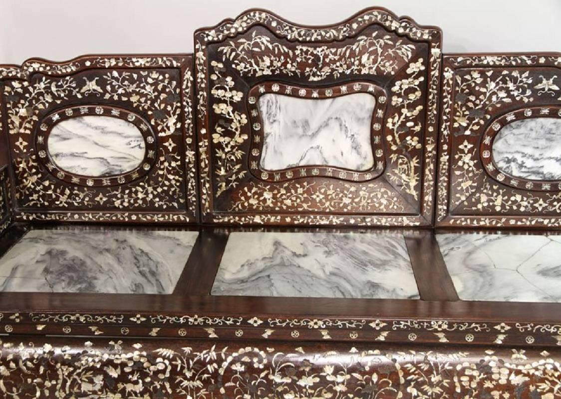 China, an exceptional early 20th century hard wood settee elaborately decorated with mother-of-pearl and stone inlays depicting pine trees, butterflies, longevity character and auspicious blossoms.

It features six (6) large-scale natural marble