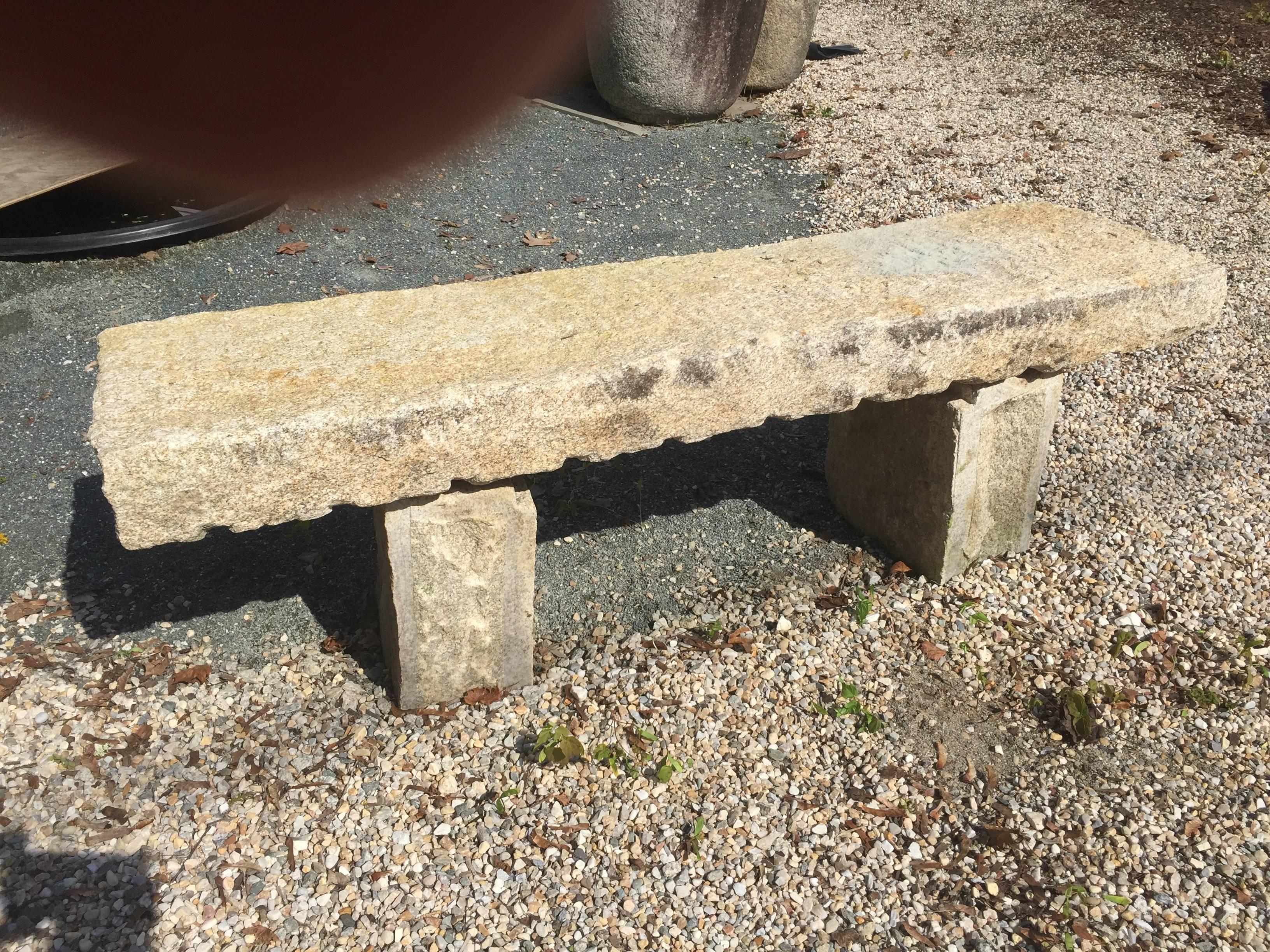 Japan, an antique hand-carved granite stone bench from an old Japanese garden. Hand-carved from solid, thick granite in three pieces with an old used patina.

Dimensions: 18 inches high and 60 inches long and 17.5 inches deep 

Age: Early 20th