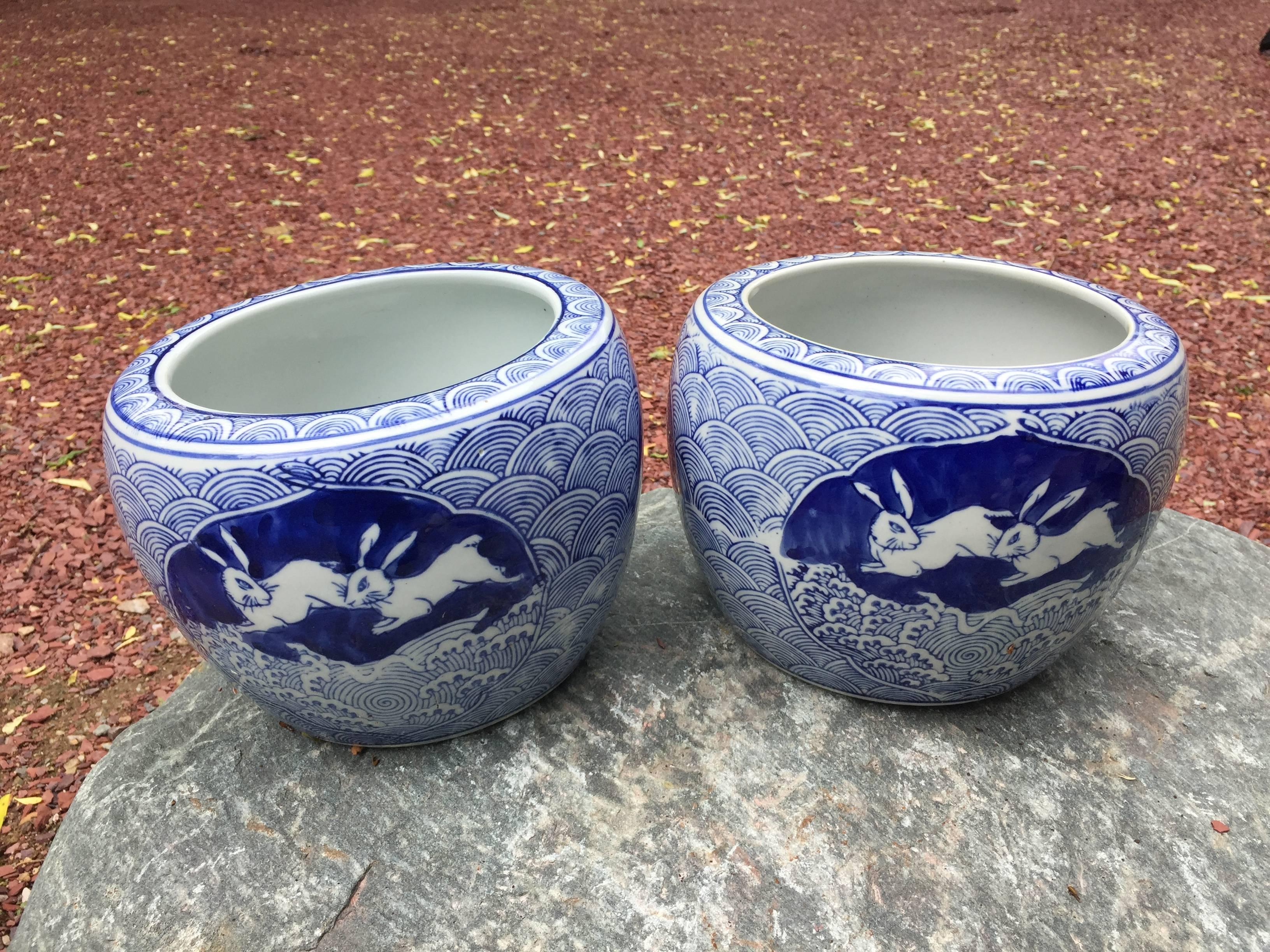 A pair of beautiful old ceramic Rabbit planters or bowls from old Japan dating to the mid-20th century with deep blue glazing in a wave and rabbit pattern, probably an Imari kiln. 

A rare find. Fine quality.

Dimensions: 6 inches high and 8 inches