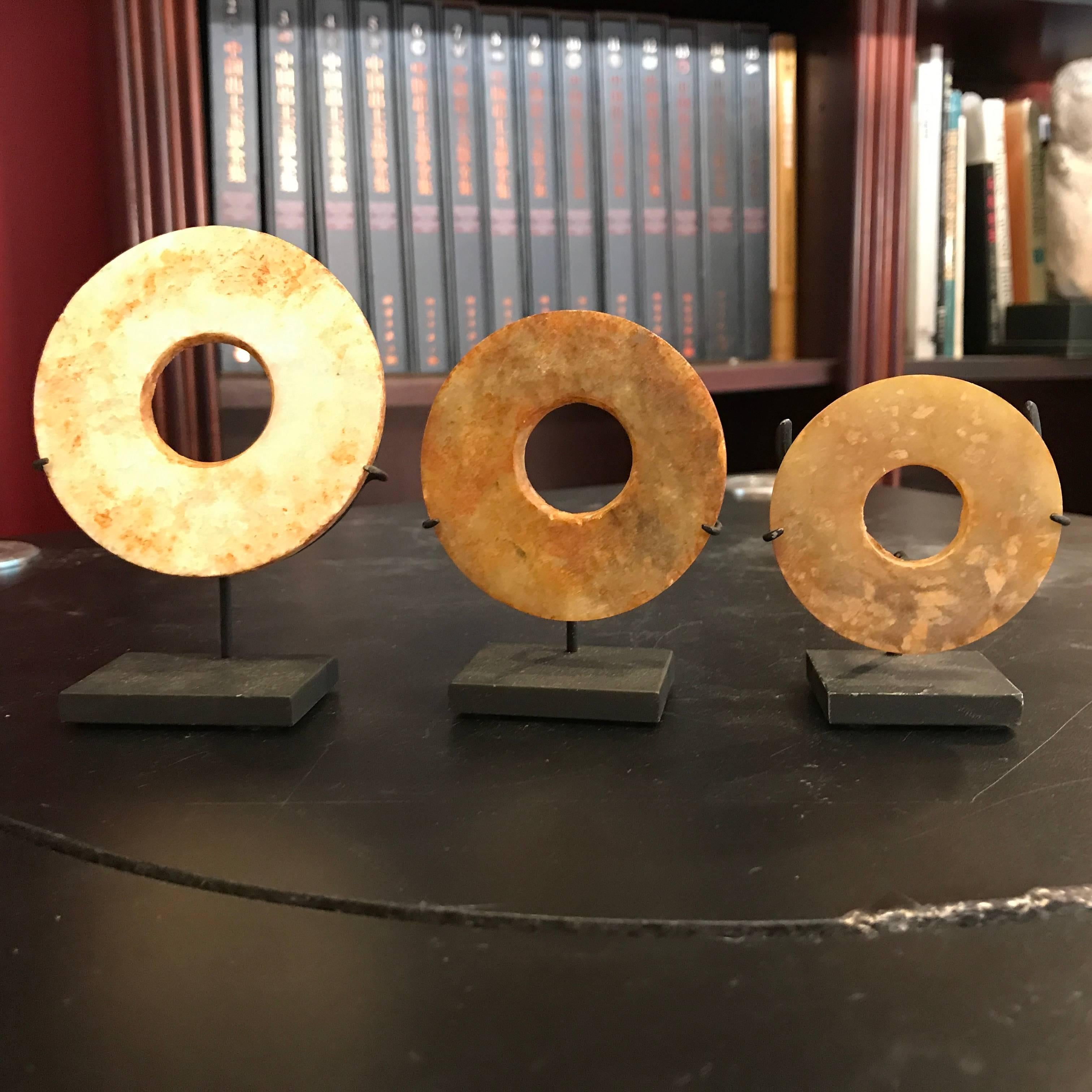 This is a grouping of three authentic Chinese ancient jade bi disc from the Qi Jia Culture, Northwestern China, 3,000-2,000 BCE. These come from our private collection. 

Dimensions with stands: 4 inches,3.25 inches. and 2.5 inches high