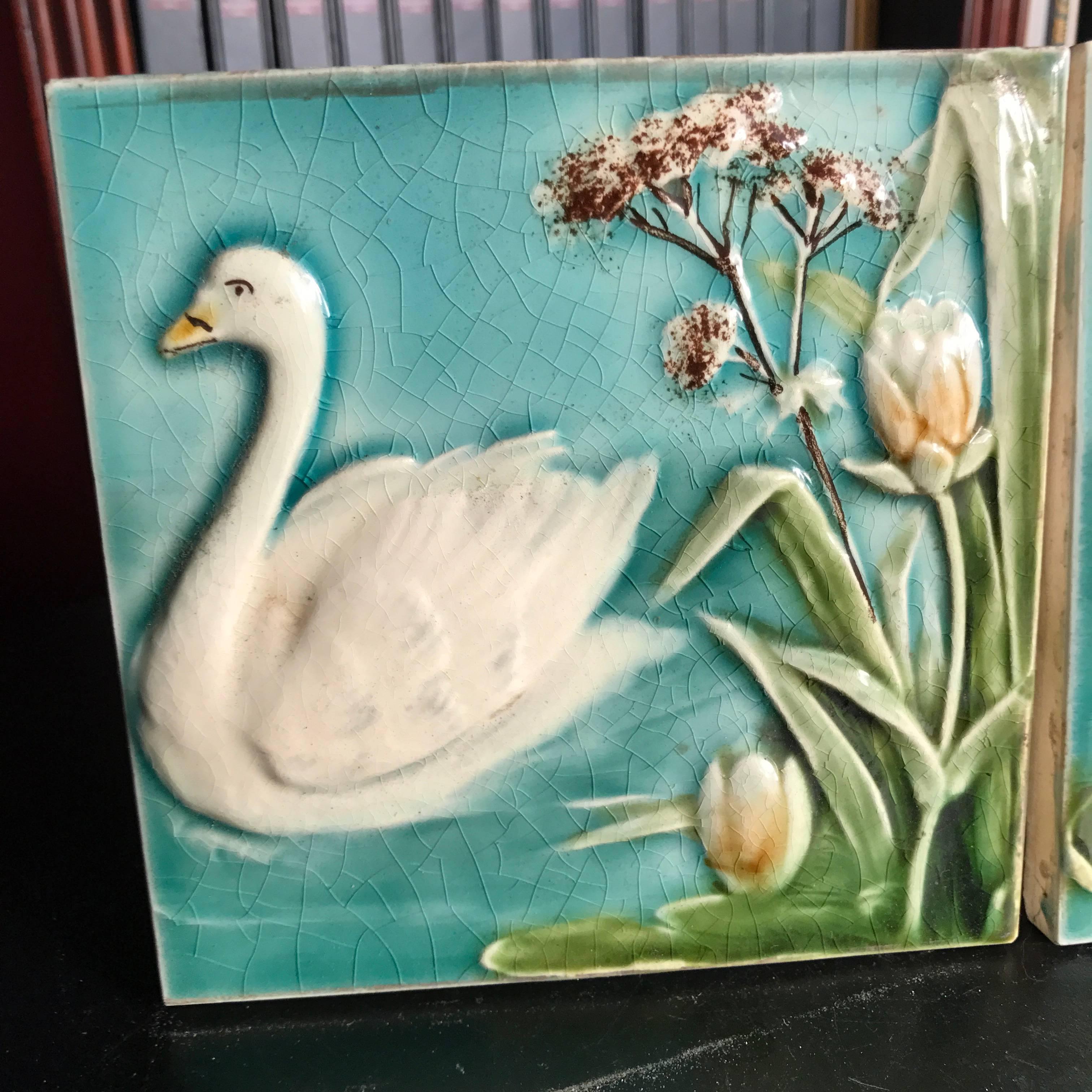 Here's a fine collection of two lovely Art Nouveau ceramic tiles dating to the Jugendstil period (1890-1919), including beautiful swan and lotus flower/lilly designs.

Dimensions: Each tile is 5.5 inches square and .375 inches thick
 Pair tiles