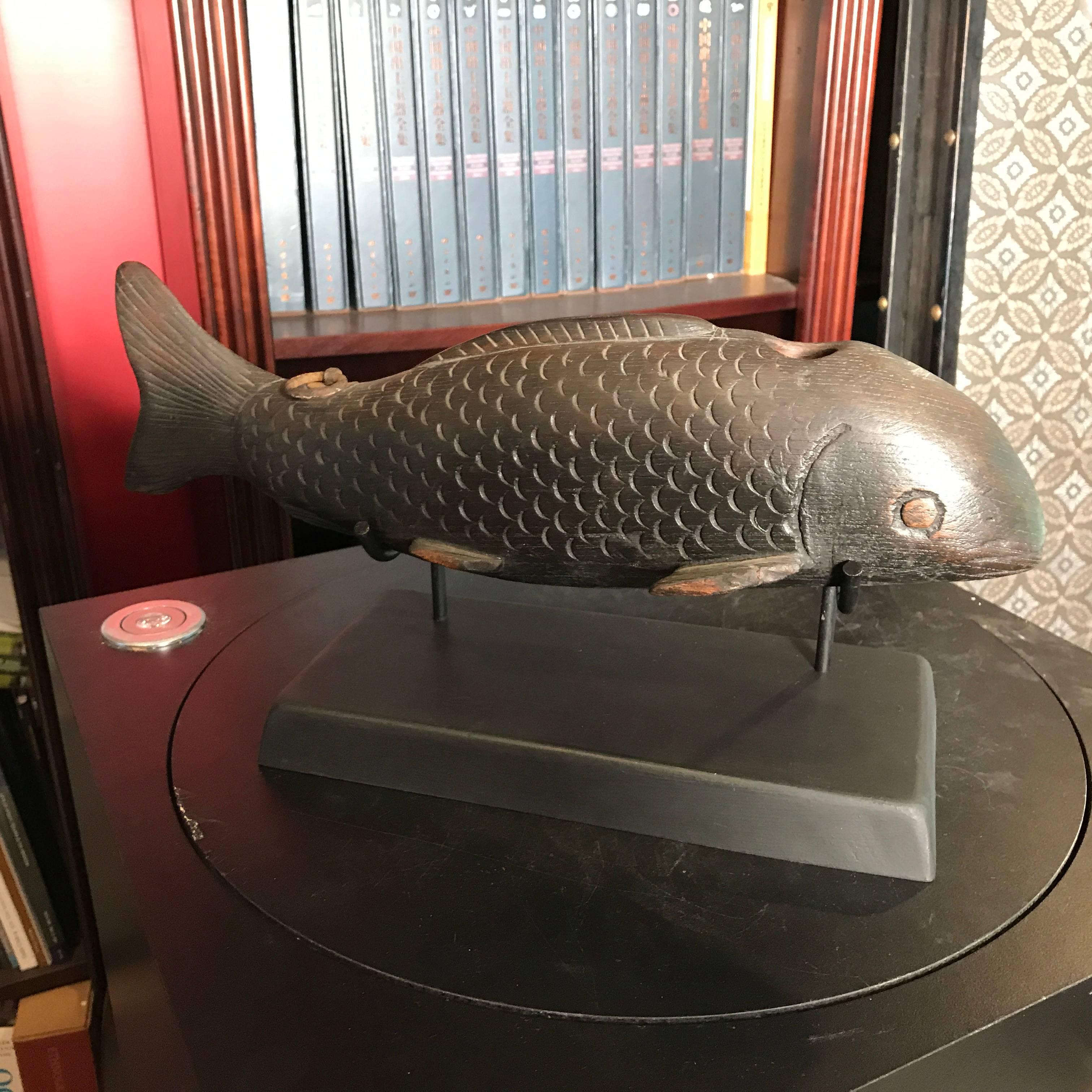 A fine old Japanese 19th century hand-carved wooden KOI fish symbolic of prosperity, perseverance and good fortune. Custom black wood display base is included.

Originally a crossbar for a hanging pot hook ensemble, these were often displayed in
