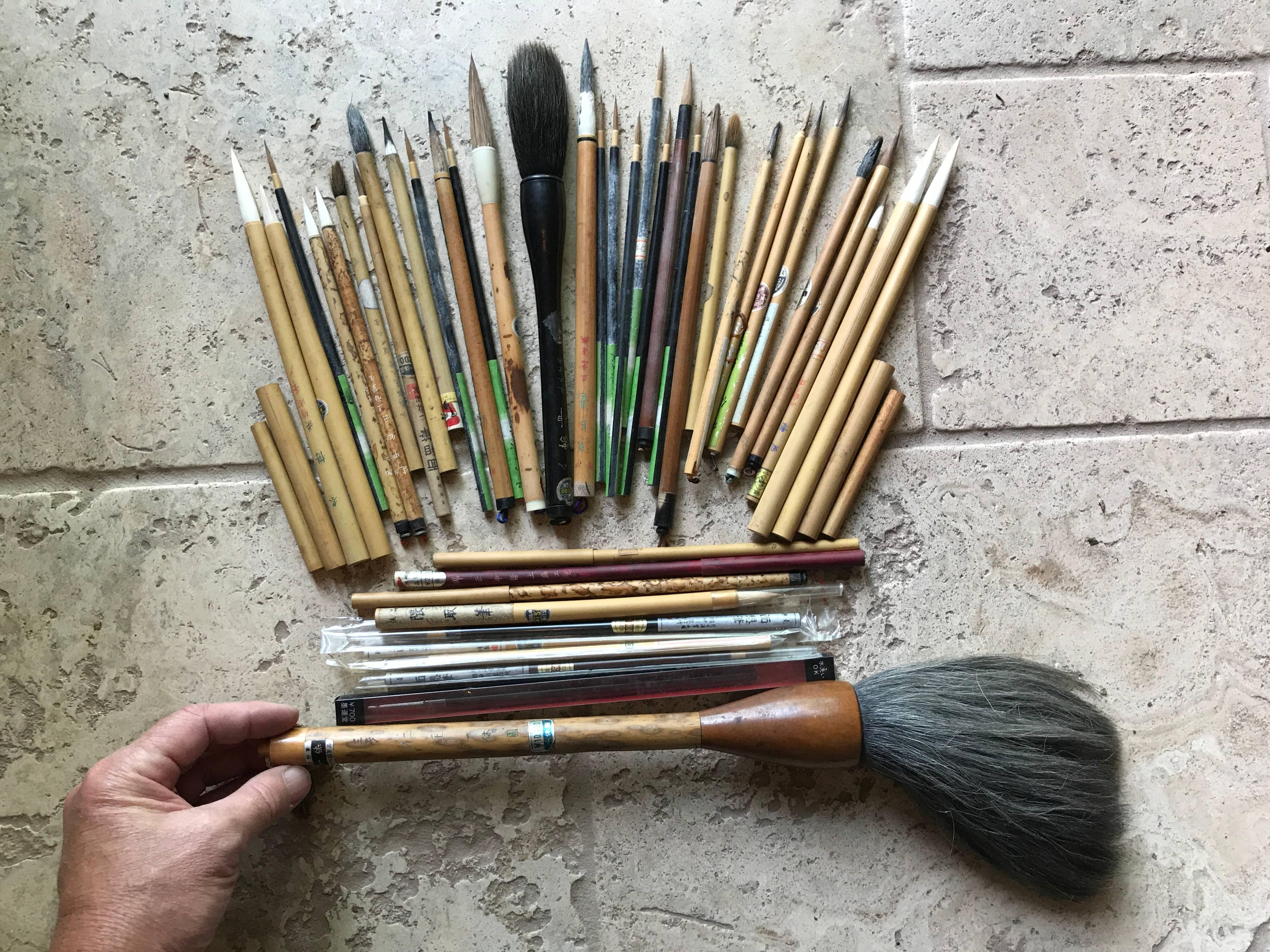 Here's a rare find from a collector we visited in Japan. A very unusual treasure from Japan. 

This is a cache of old and antique Japanese and Chinese bamboo paint and calligraphy artist brushes dating back to the 1940s. The bundle includes new