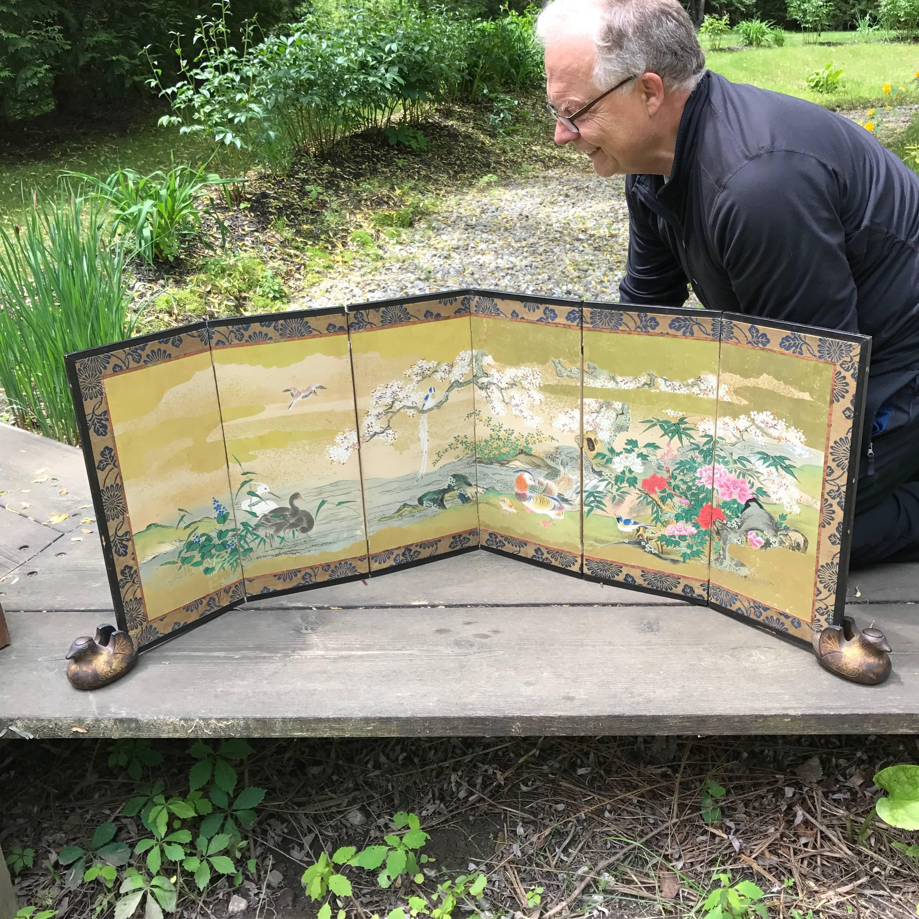 A fine early small-scale Japanese antique hand-painted six-panel folding screen byobu conceived in a convenient size 19.5 inches high and 52.5 inches length.

One of a rare pair currently available. (see other listing)

Lovely vivid colors