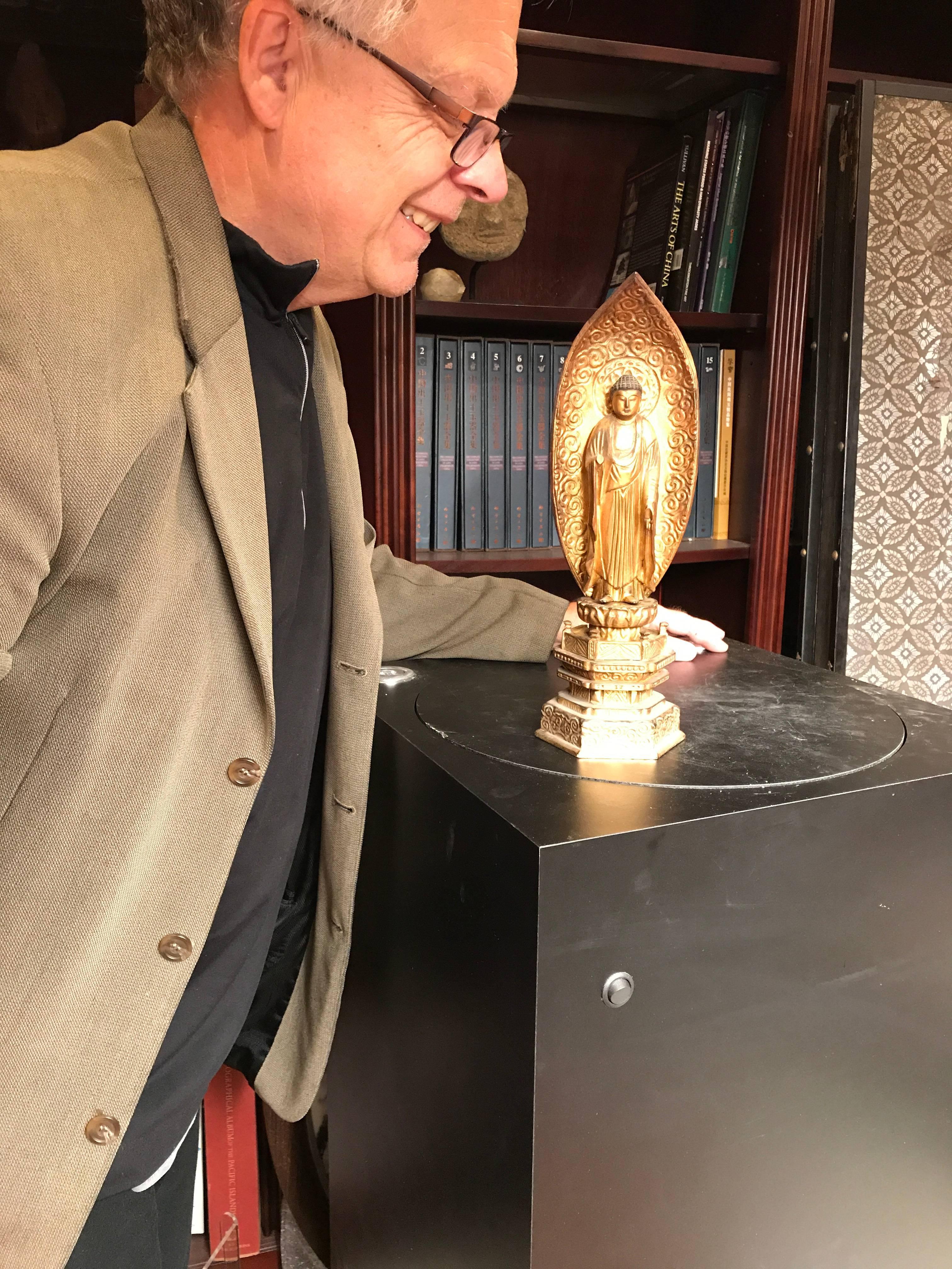 This is a lovely Japanese gold gilt and lacquered wooden Buddha standing in compassionate mudra. We acquired it from a large Japanese collection this past year from one of many buying trips.

Our Buddha was hand-carved and hand gilt and then the