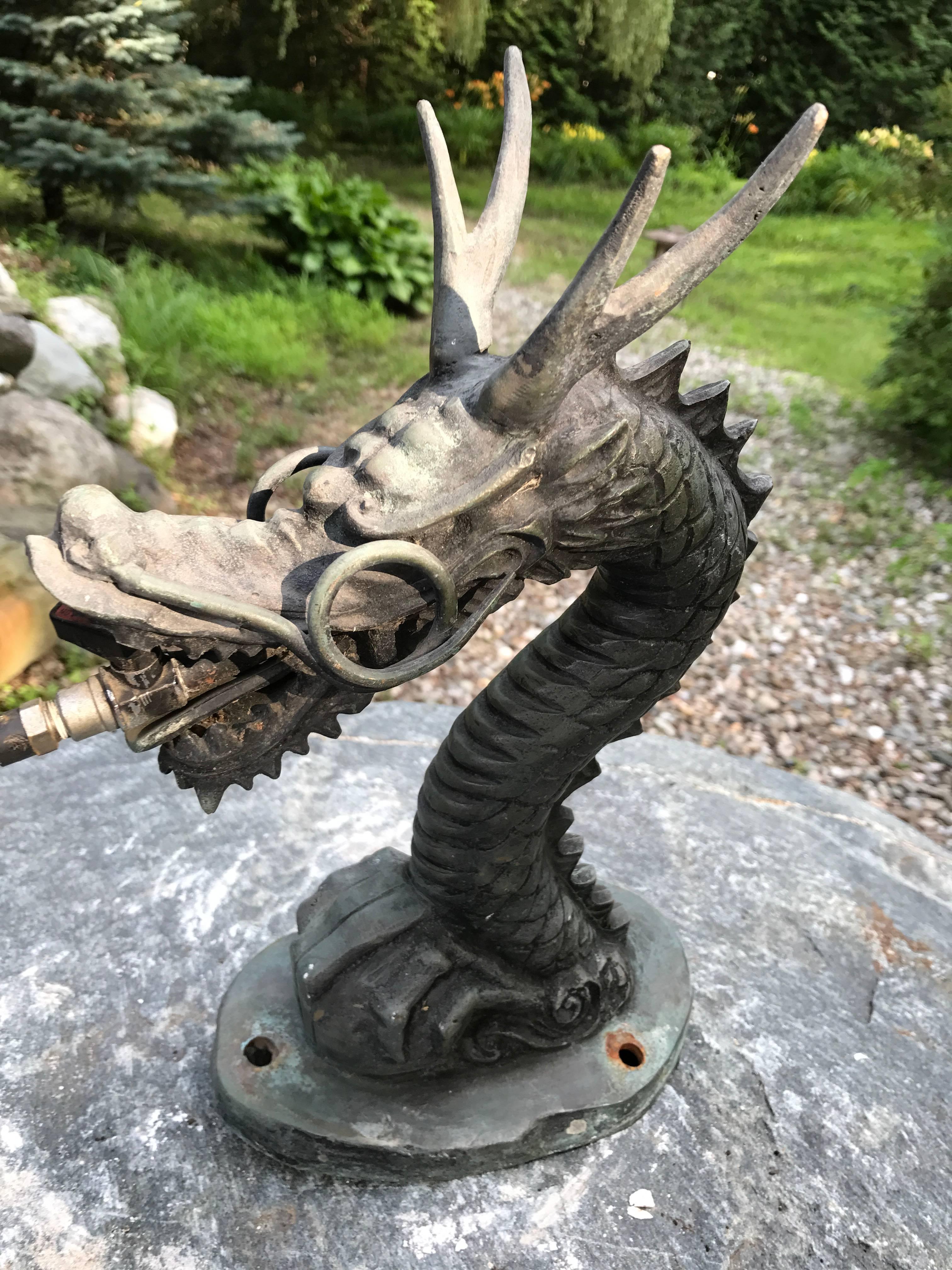 Japan, a hard to find hand caste, hand-wrought bronze dramatic dragon sculpture constructed for/as a temple basin spout - formerly attached to a stone or bronze basin. It possesses excellent detail and retains the old water tube attachment and with