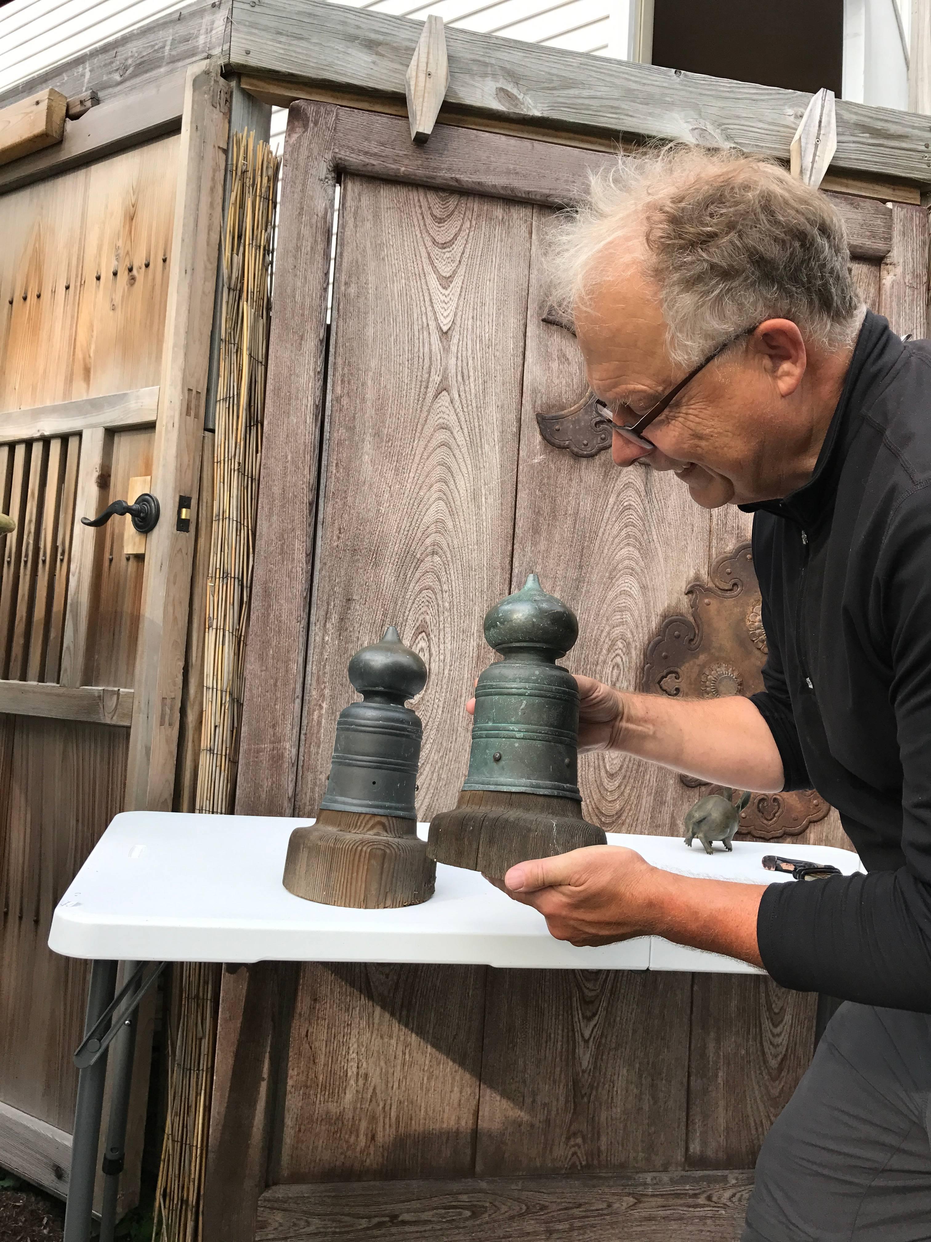 Here's a rare, seldom found pair of old hand cast bronze Japanese Buddhist temple post or bridge post top giboshi that date in the 19th century. They still retain their original inserted cedar post top fragments and each possesses a rage signature