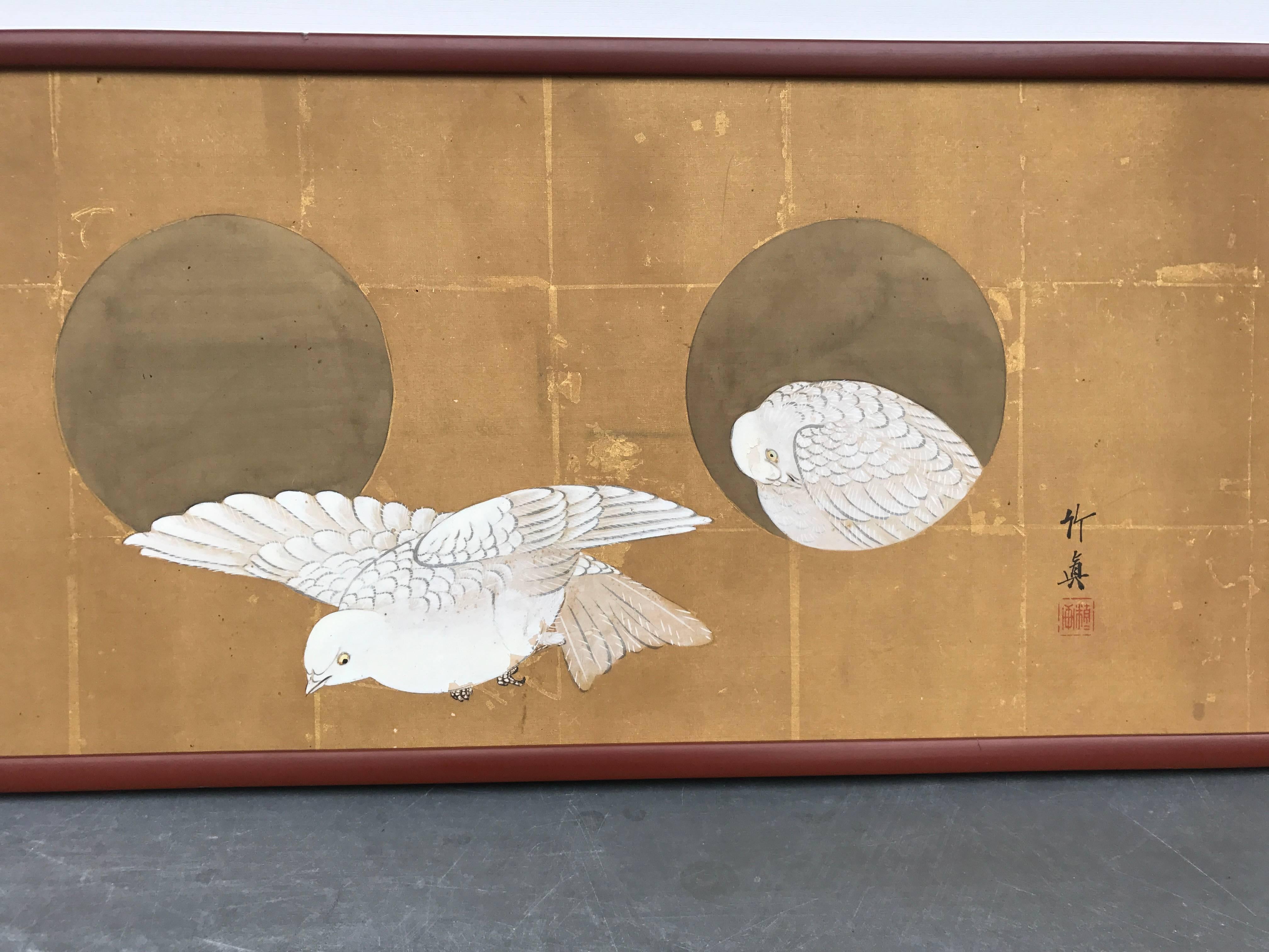 FEBRUARY SALE - NOW SAVE 25% AND MORE

Japan a simple antique Painting -Gaku-, on silk, of a pair of white peace doves rendered against multiple golden brown moon shapes, perhaps an entrance to a bird dwelling, the peaceful work finished with a red
