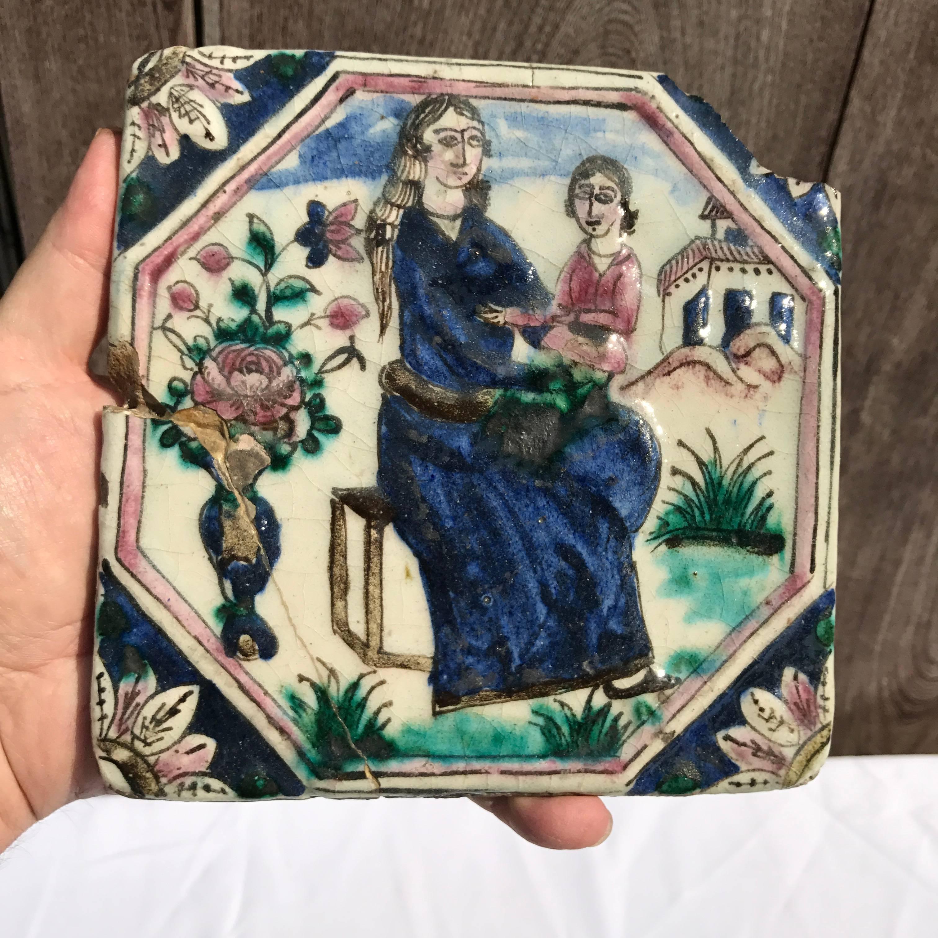 Collection of three (3) large antique hand-painted Persian Ceramic Tiles dating to the later 19th century. Handsome images and colorful glazes. 
Each tile depicts a figure:
#1 woman and child
#2 woman on horse back
#3 Nobleman clutching a