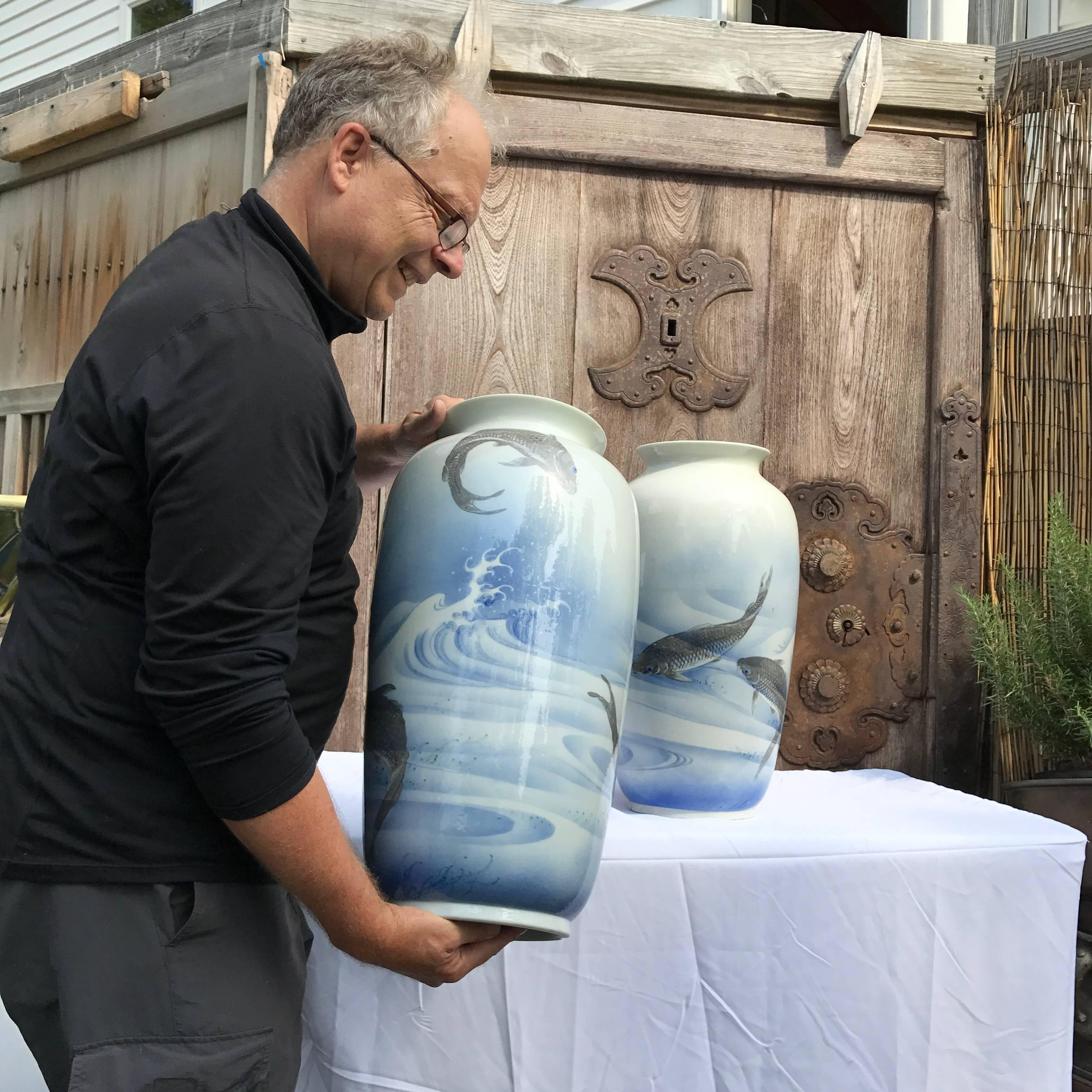 A large Japanese antique near pair of handsome, hand-painted blue and white ovoid form koi and wave motif vases dating in the early 20th century.

They are signed on bases with an eight character mark of Seto Kawamoto Masukichi seso.

Dimensions: