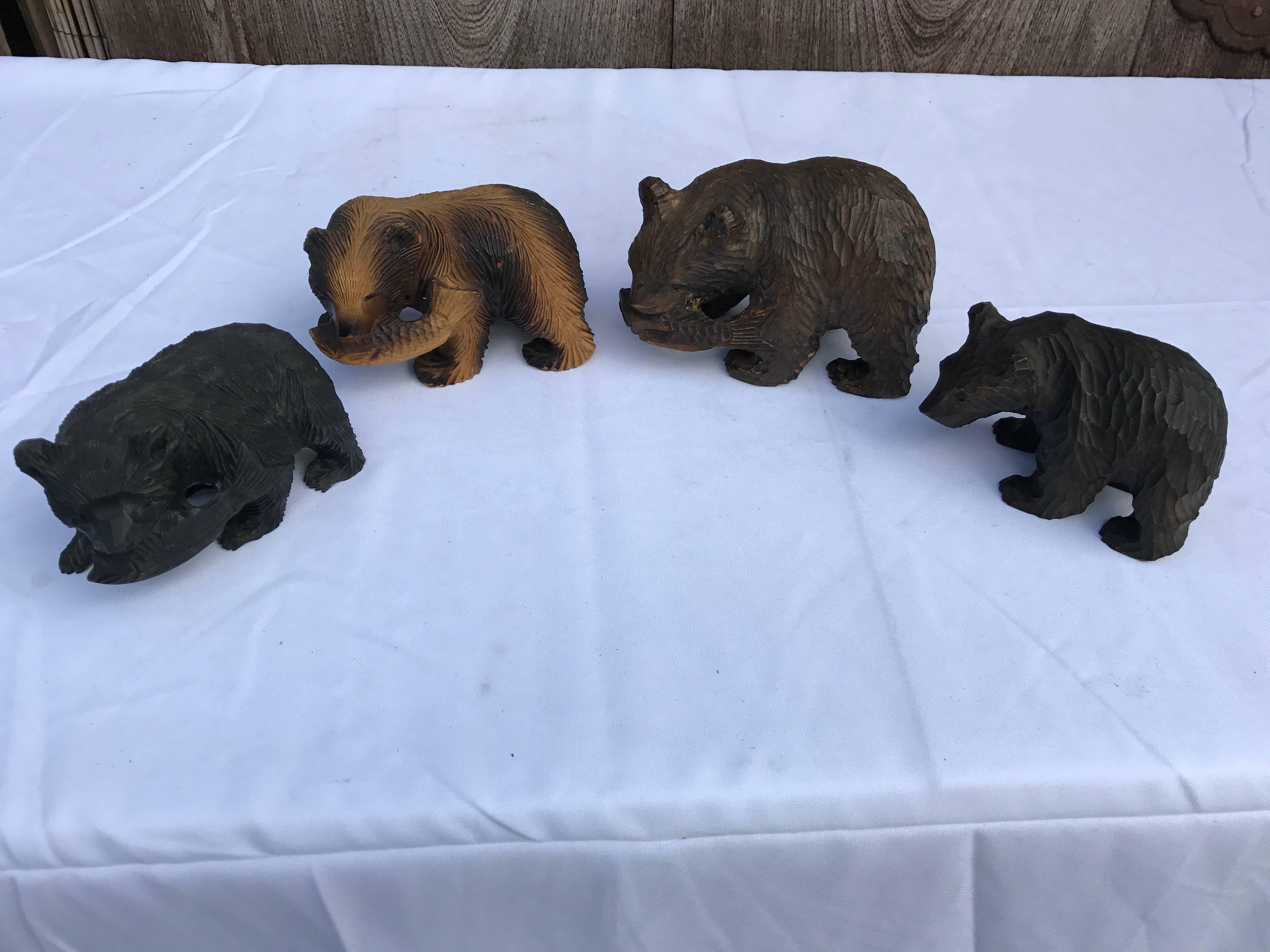 Japanese fine old handmade and hand-carved foursome wooden carvings of bears Higuma individually crafted from cryptomeria (cedar) wood.

Two are grasping salmon.

Quality: Ittobori style (carved from one wooden piece), Ainu Peoples, Hokkaido