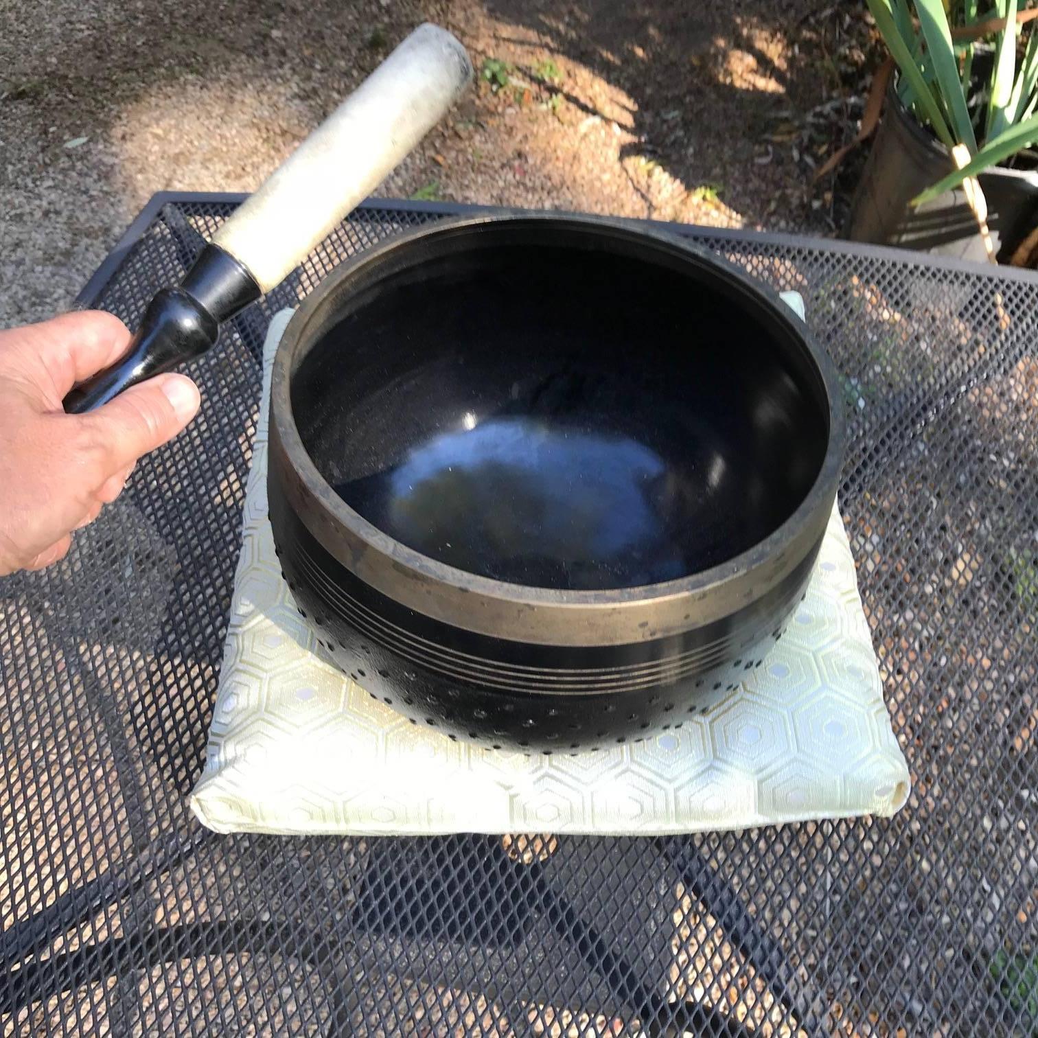 Soothing Sound Guaranteed to please you...

This is a lovely Japanese old black and gold temple bell- one of the larger hand-hammered bronze temple bells that comes with its own plush cushion and striker- a complete set.

The bell is handcrafted- a