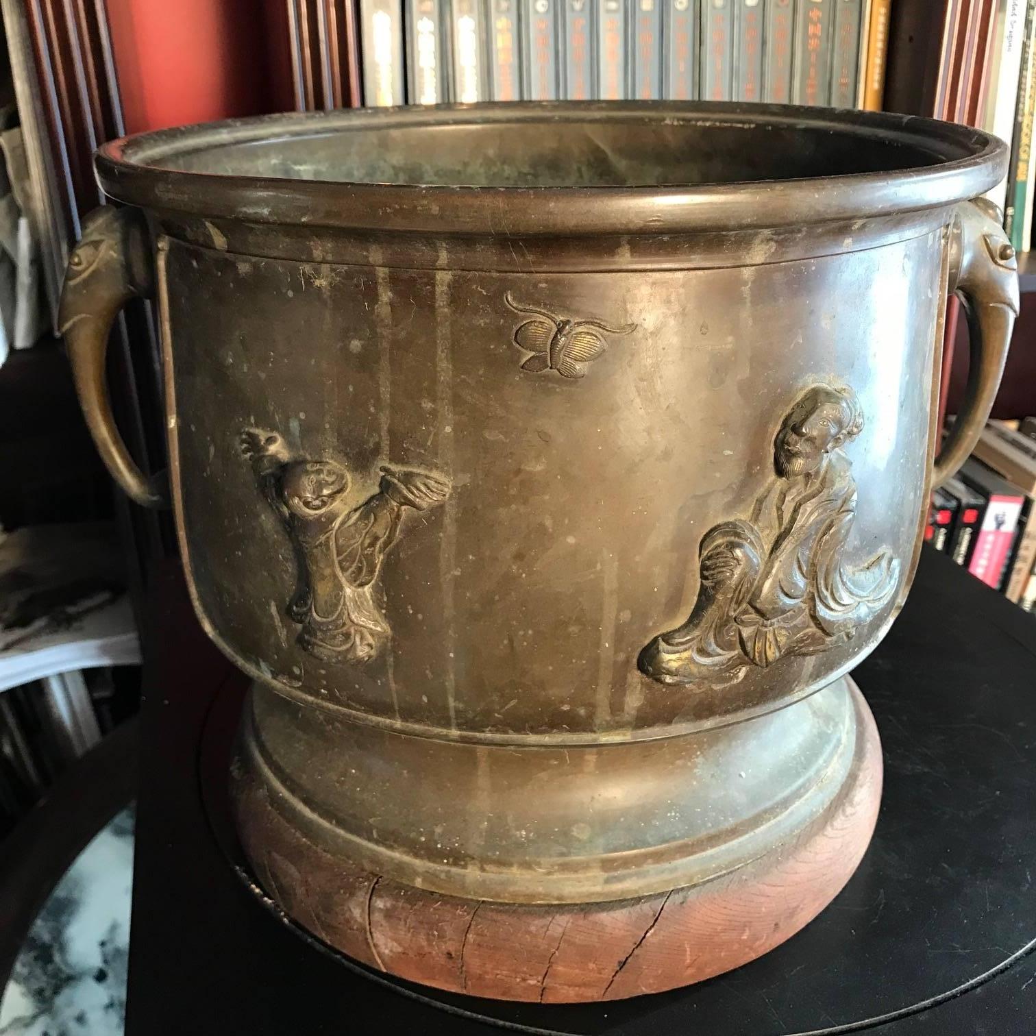 A fine Japanese cast bronze planter/hibachi, Meiji period, 19th century. Likely crafted by a samurai metal specialist- finest craftsmen in the world- before the turn of the last century.

Unusual theme: Playful Children chasing butterflies, a