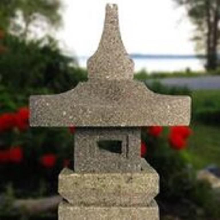 Japan a modest sized stone -Yukimi-lantern in square form ideally suited for a small tea garden out of doors or inside in your favorite sun space. 

The striking and well proportioned stone lantern is fashioned in four parts for easy portability and