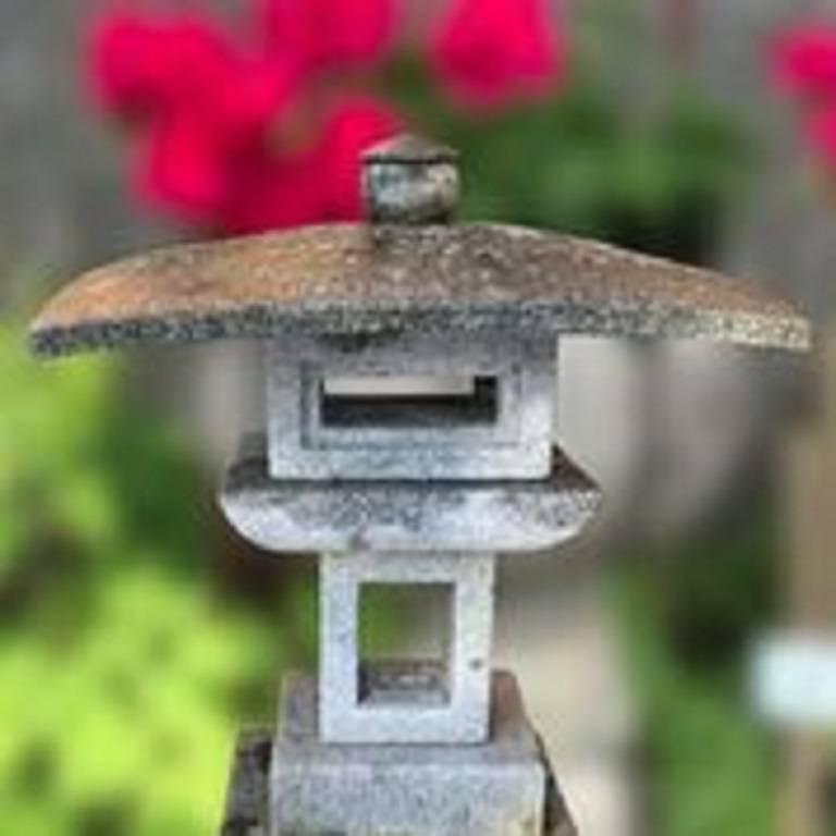 An unusual and very nice sized stone -broad roof- vintage lantern carved from solid granite and ideally suited for a small to medium garden out of doors or inside in your favourite sun space. 

The striking and well proportioned stone lantern is