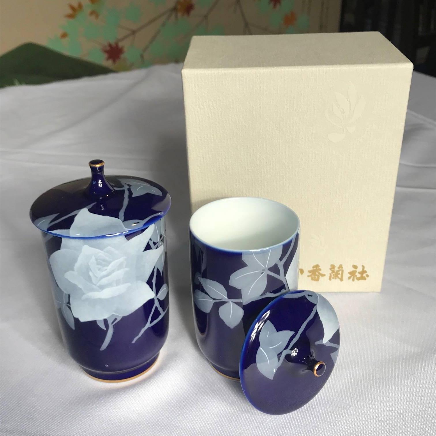 From Japan, a beautiful hand-painted and hand glazed lapis- cobalt blue pair of tea cups with brilliant white flowers and gold gilt high lights.

Perfect tea lover's delight. Mint condition.

Dimensions: Tallest tea cup is 4 inches tall and 2 inches