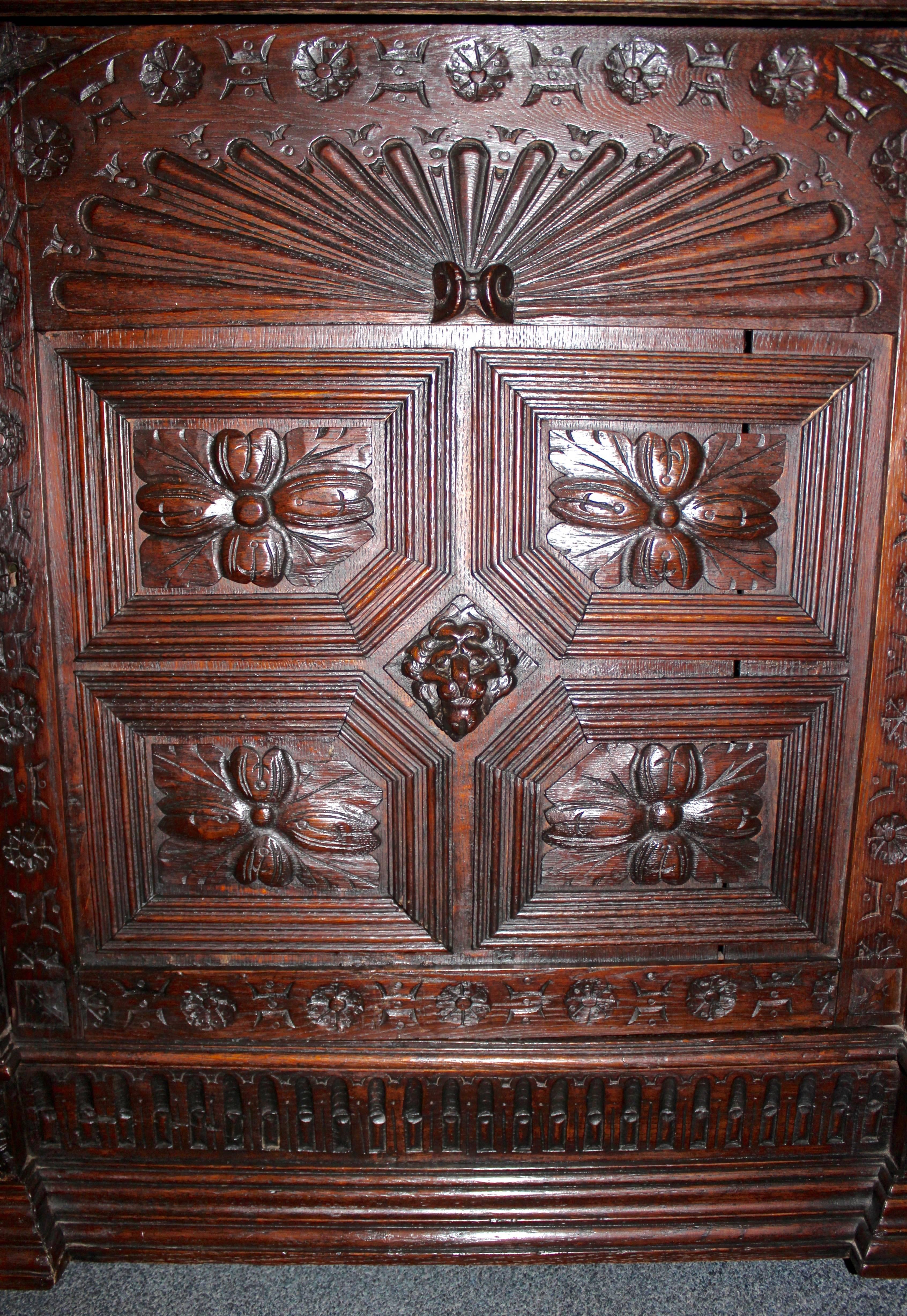 This French cabinet is made in the Renaissance style.  It is hand-carved from oak and features intricate carvings reminiscent of the style.  Storage in the piece includes an upper pull-out drawer and a lower cabinet with a shelf.
