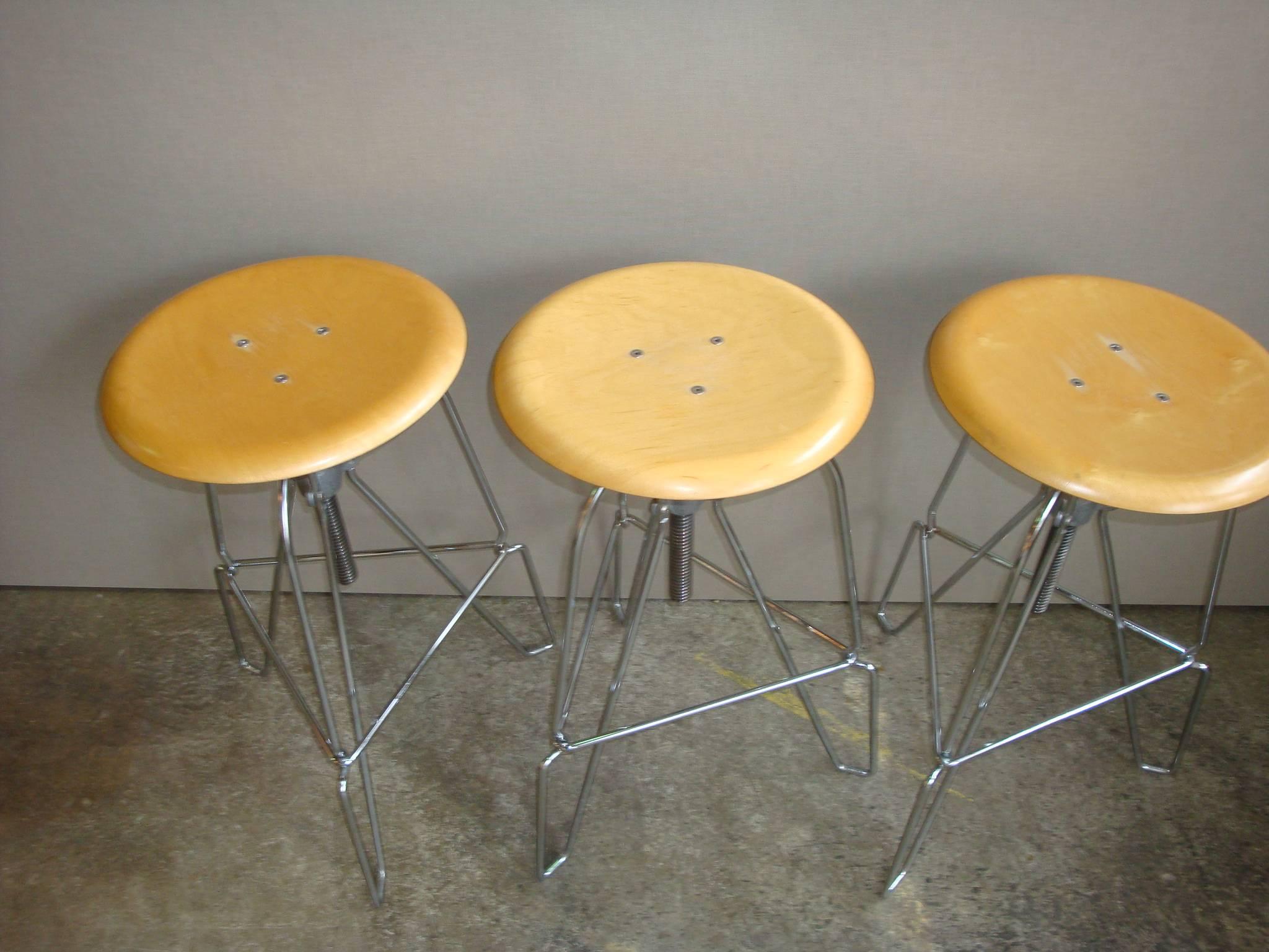 This is a set of three Jeff Covey for Herman Miller model 6 stools. The legs are chrome with a maple seat. The height is adjustable 23-28.