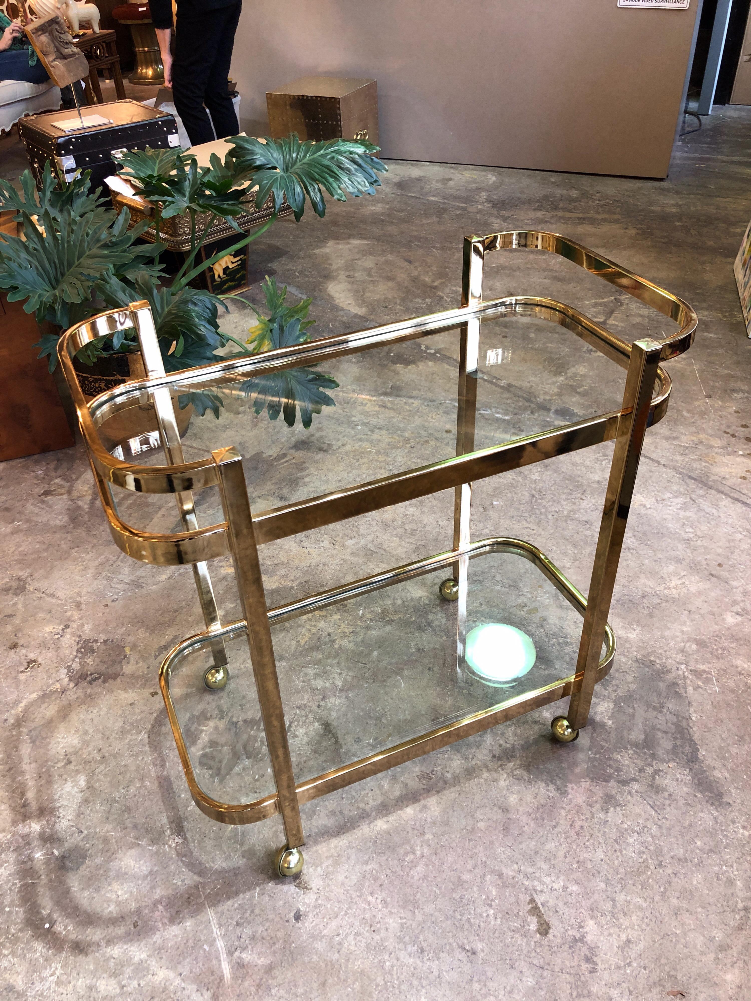 This is a Milo Baughman for Thayre Coggin brass and glass bar cart from the 1970s.