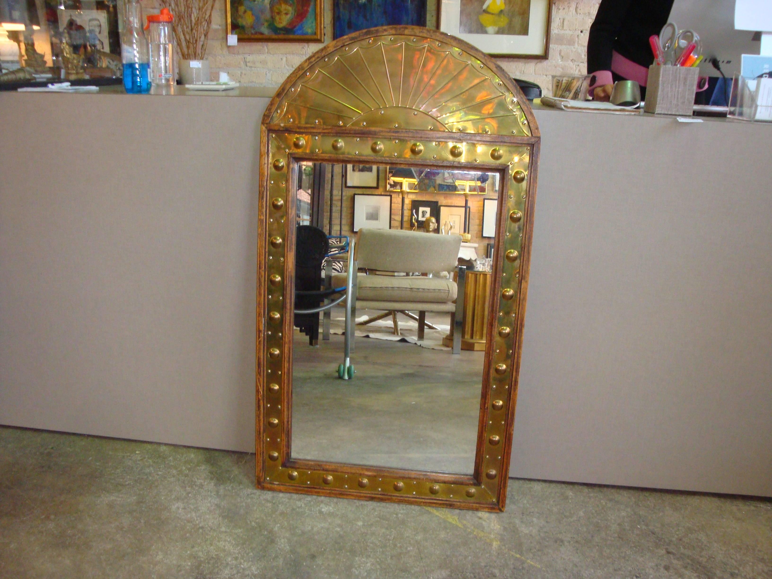 This is a brass and wood mirror from midcentury 