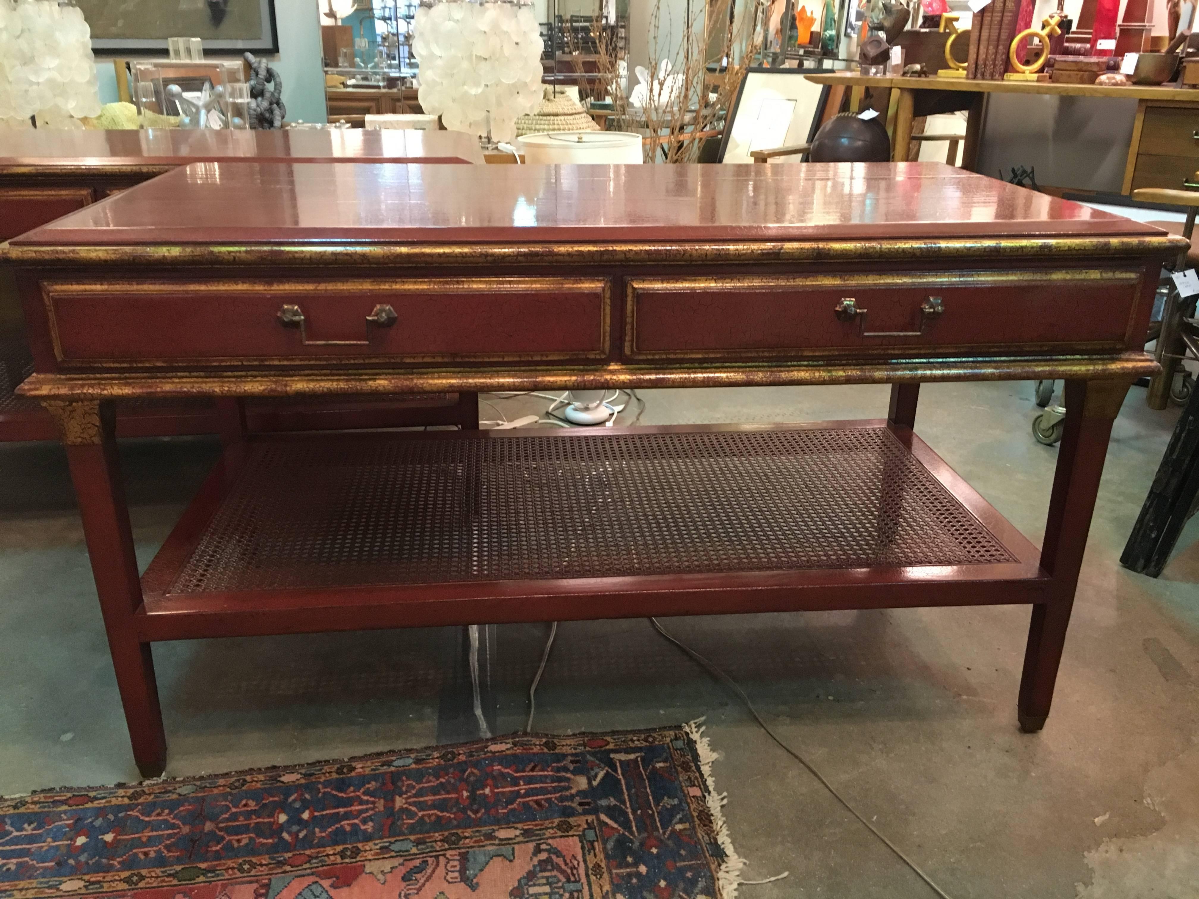 A pair of Rose Tarlow Louis XVI style nightstands. Tables with caned shelf and two drawers, in a red crackle lacquer finish with gilt trim. Some scratching on the tops as shown in pictures.