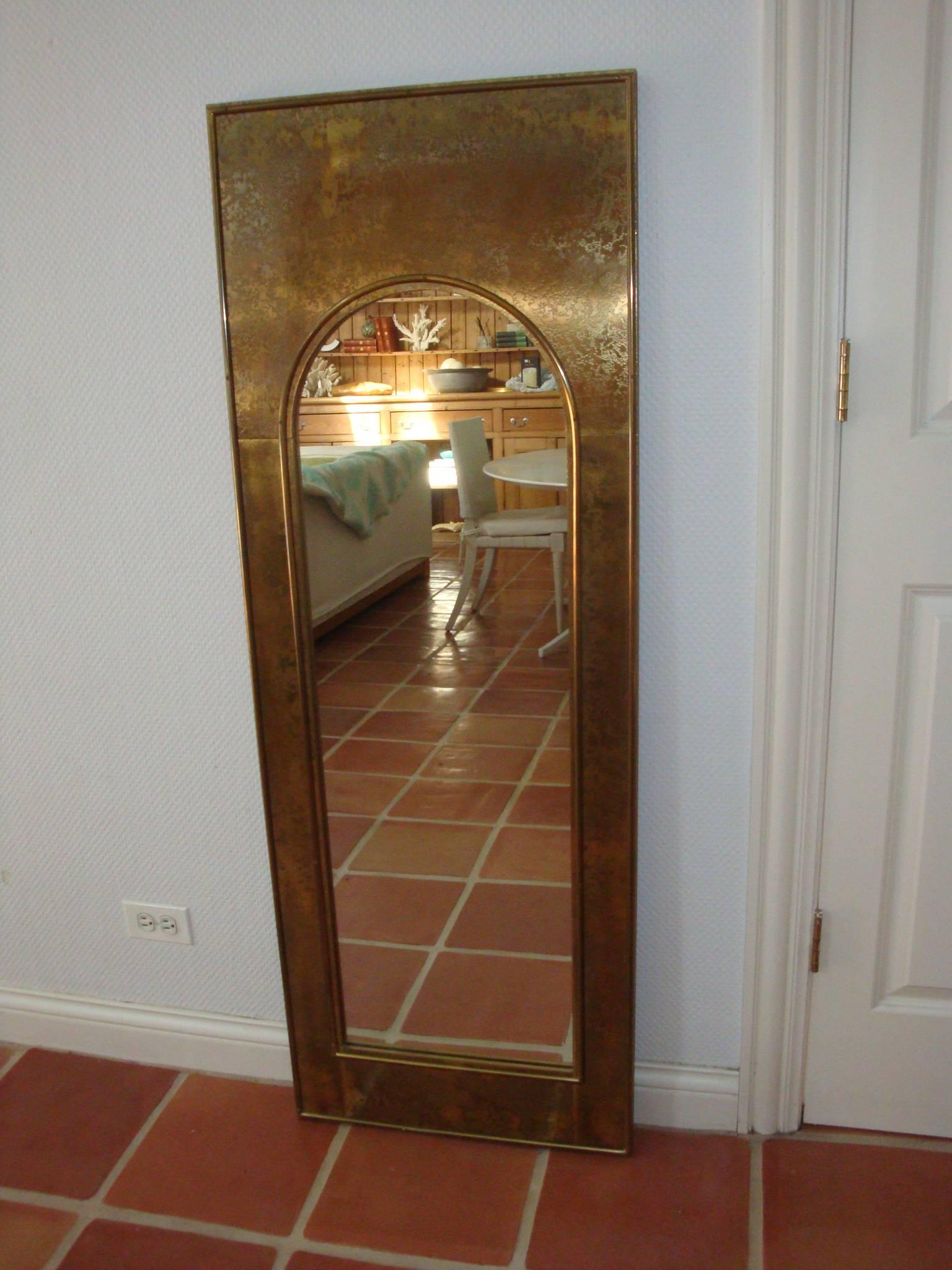 This is a brass clad mirror by Mastercraft from 1970s 