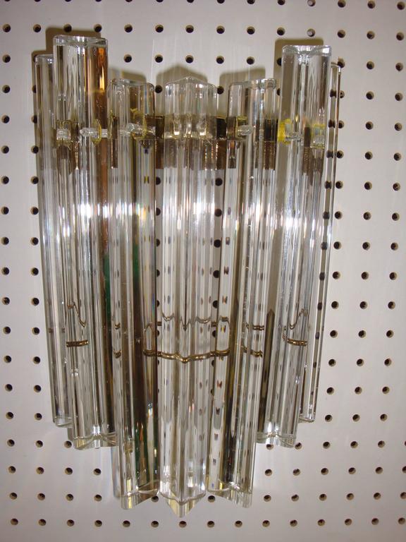 This is a pair of vintage Camer glass and gold sconces from the 1960s.