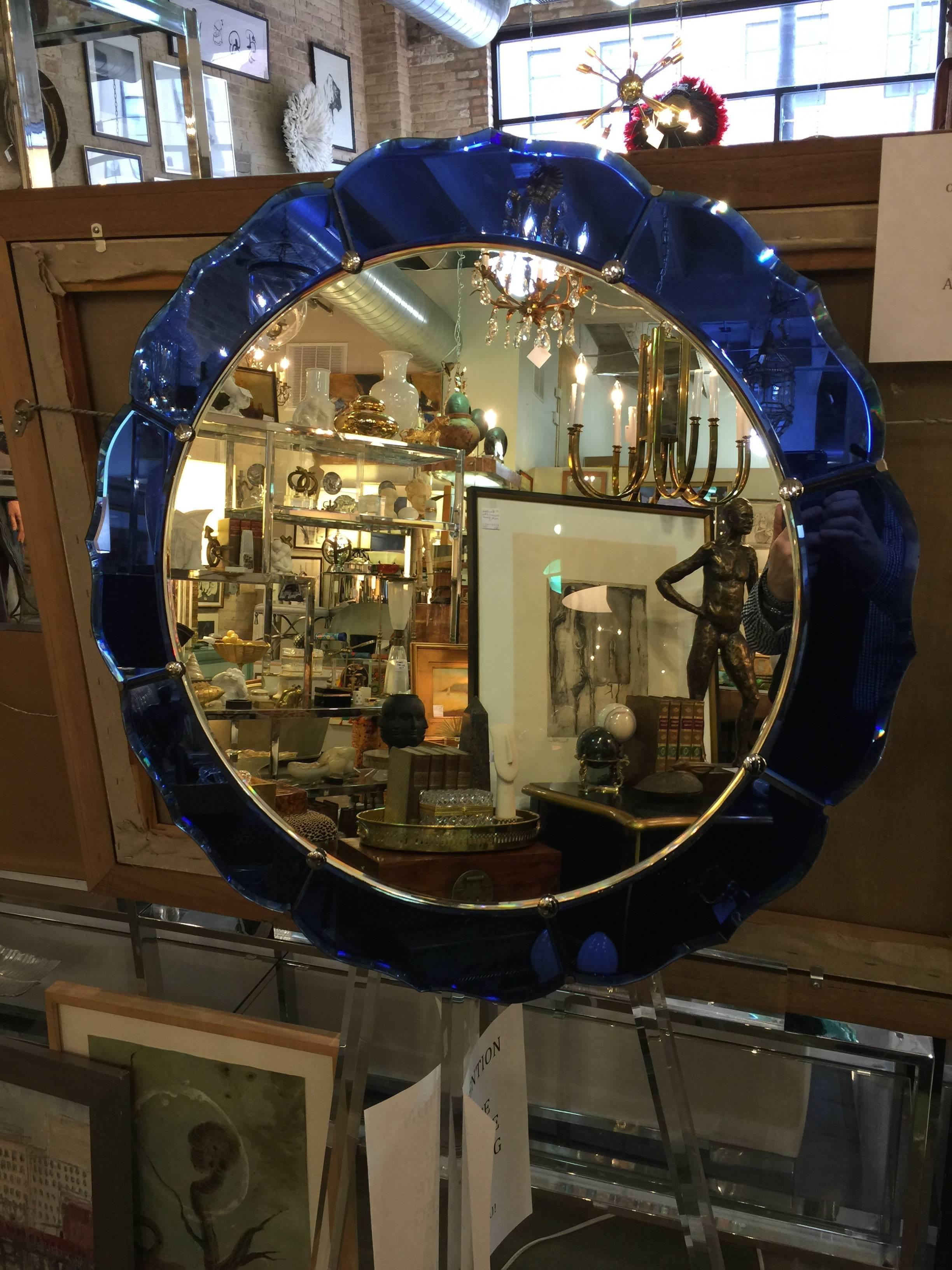 A 20th century Art Deco scalloped round cobalt blue mirror.
