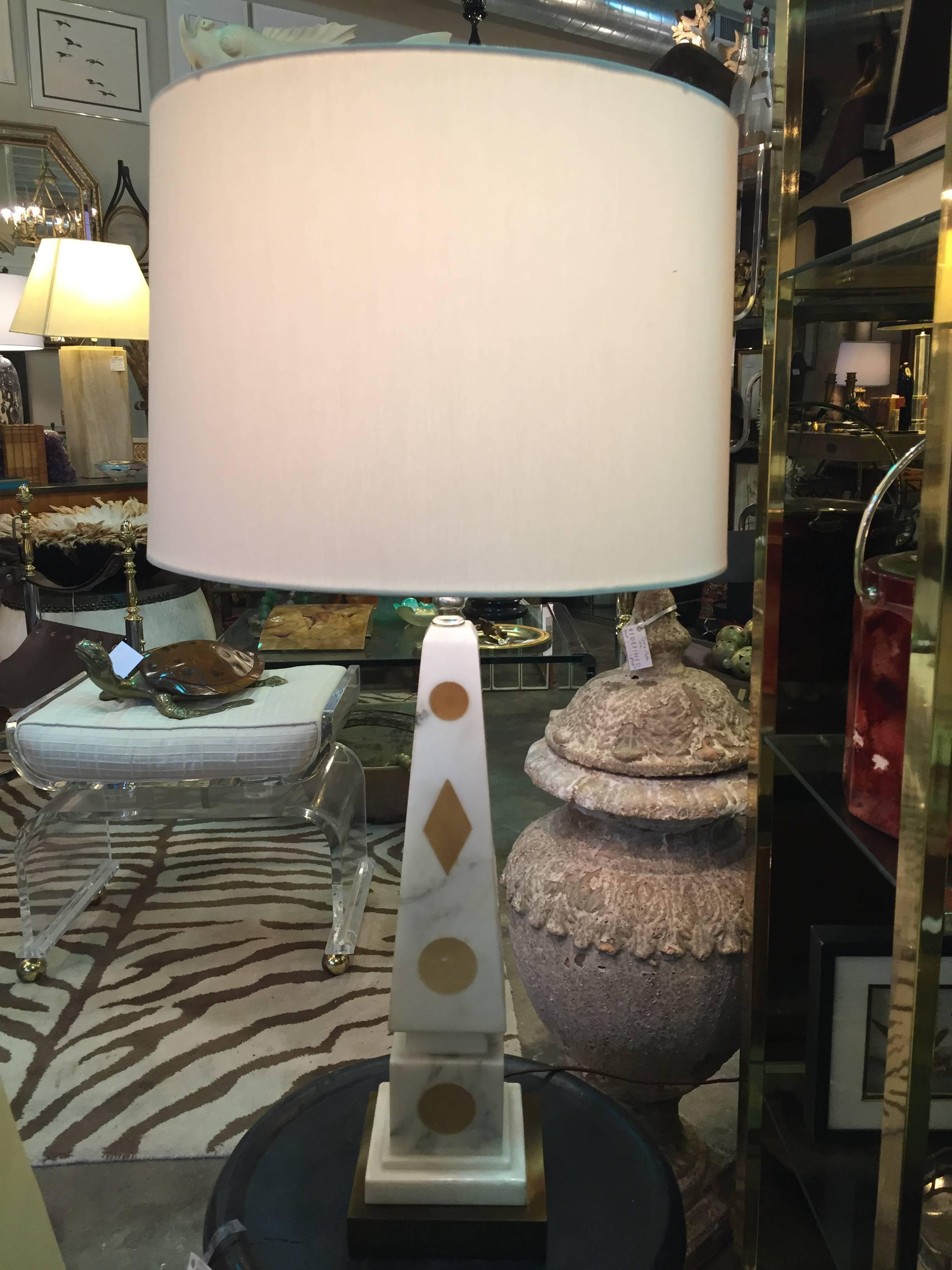 Pair of mid-20th century Italian marble obelisk table lamps having subtle gold geometric shapes against the white marble ground. New linen drum shades are included.