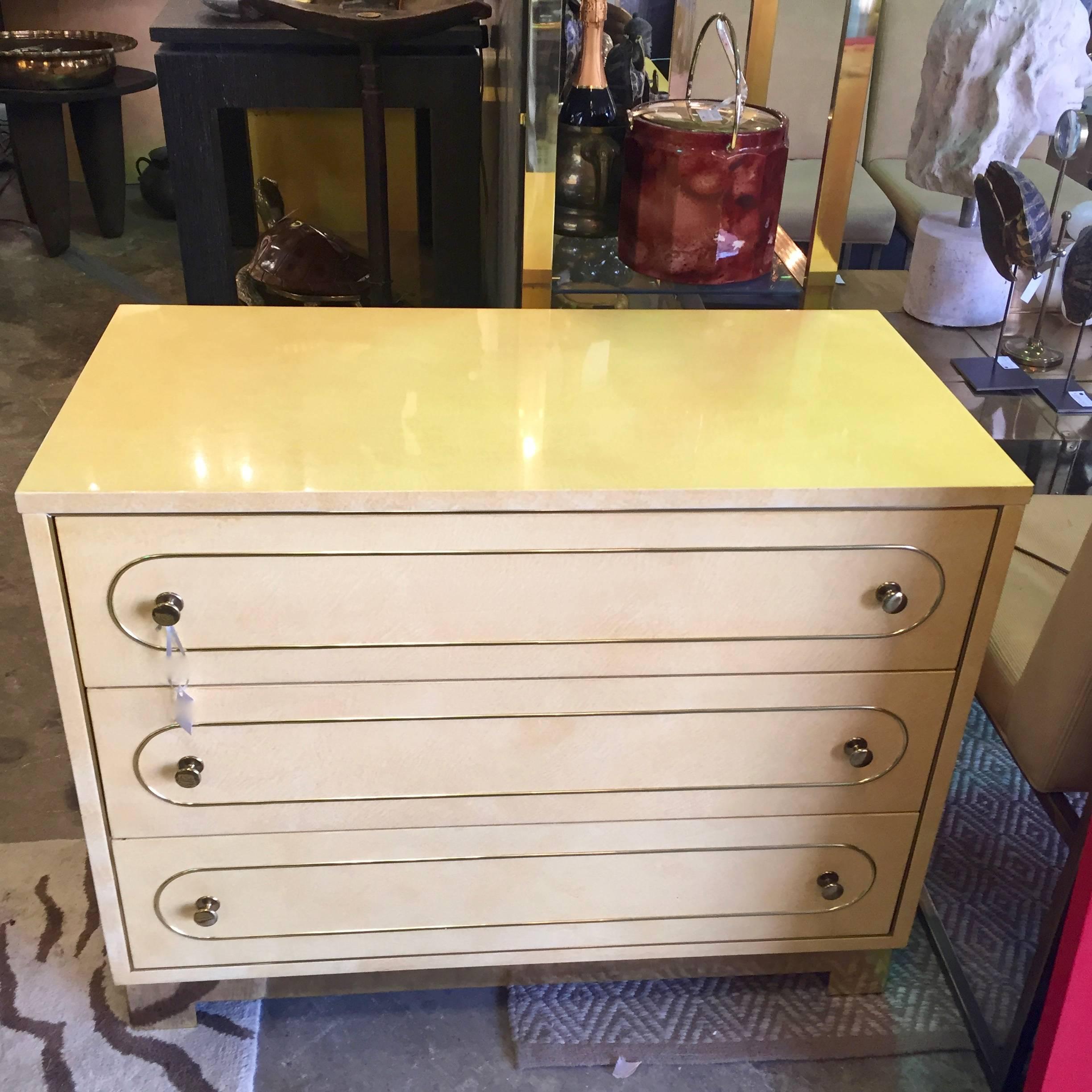 Pair of Romweber lacquered oak chest of drawers each having three drawers with applied brass trim upon a brass plinth. These would make great night chests.