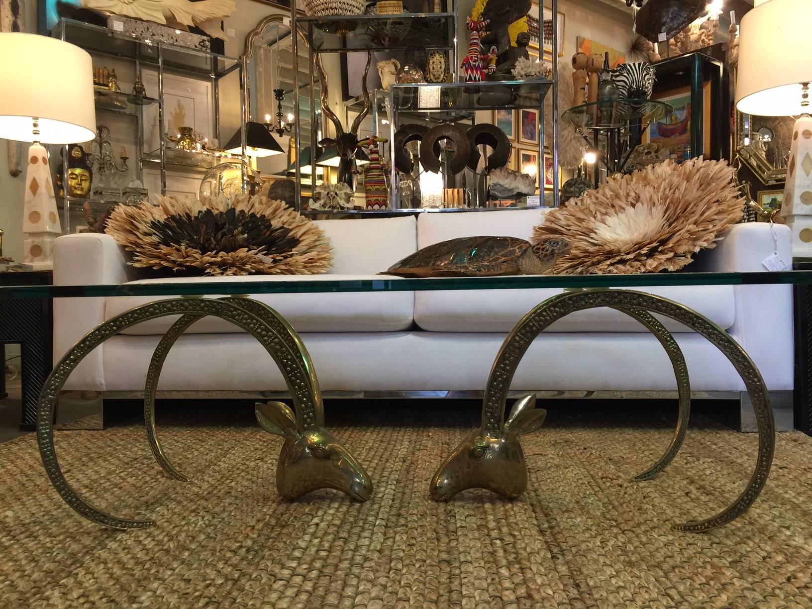 Vintage brass ram's head or Ibex coffee table. Glass top has beveled edge and is 1/2 inch thick.Can be sold separately.
