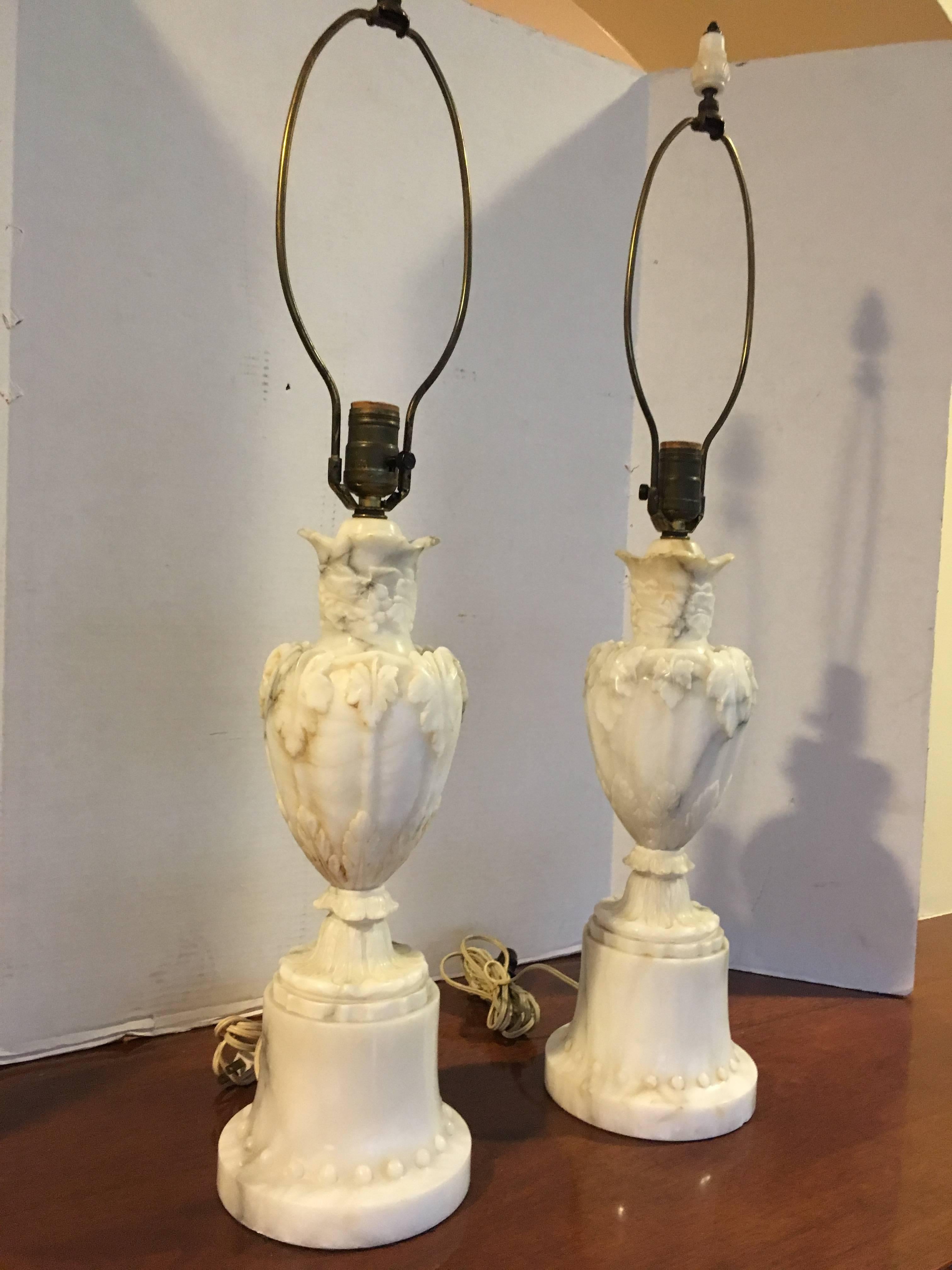 A pair of carved marble lamps from Italy.