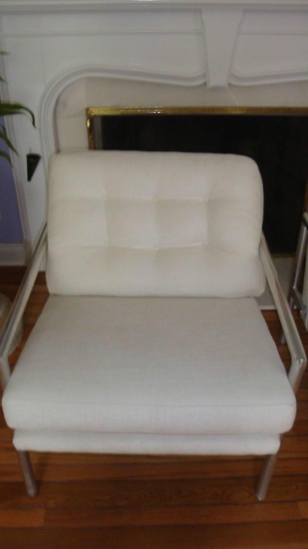 These are a pair of vintage Milo Baughman style armchairs that have been newly upholstered in a white chenille fabric.