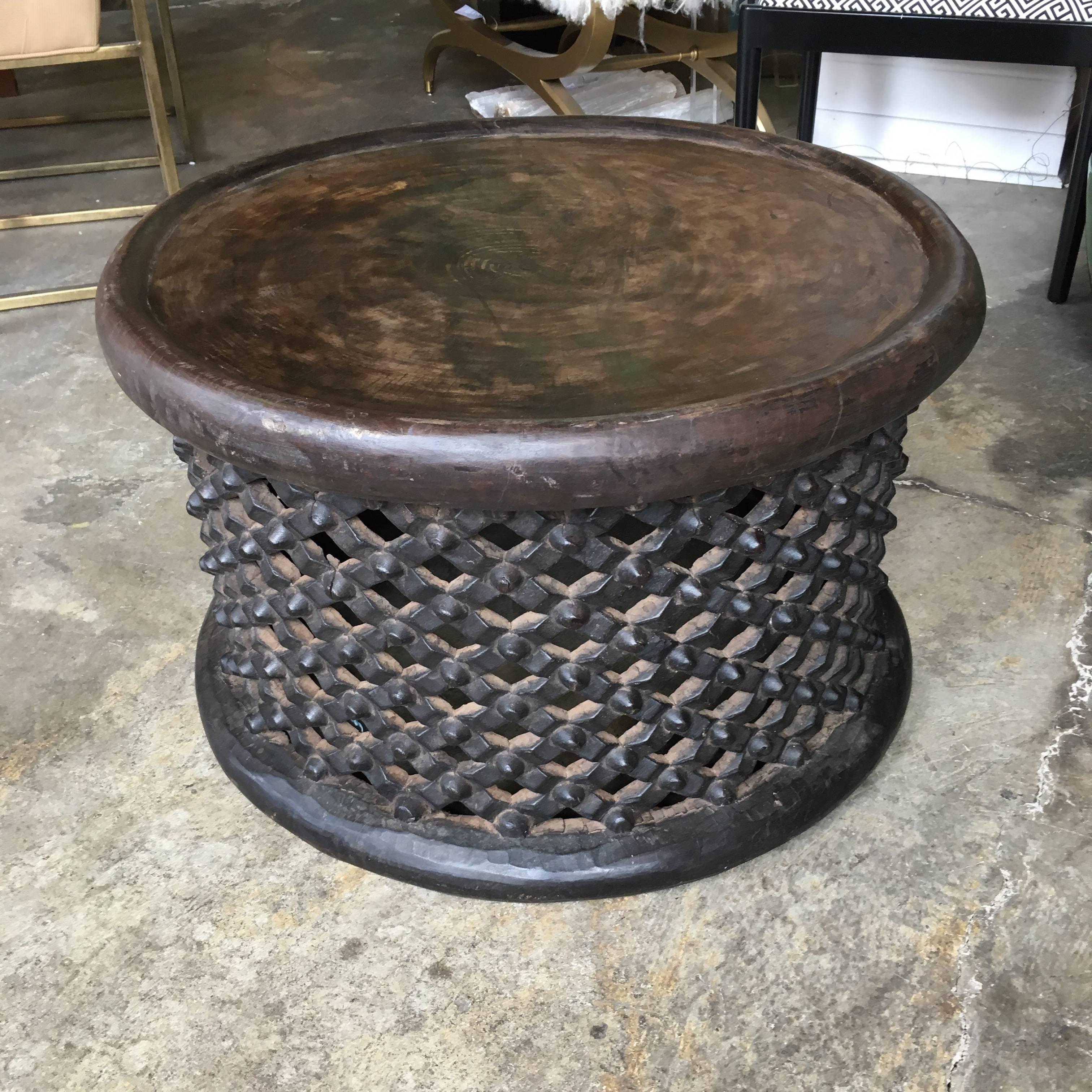 A hand-carved Bamileke spider table or stool carved from one piece of wood.